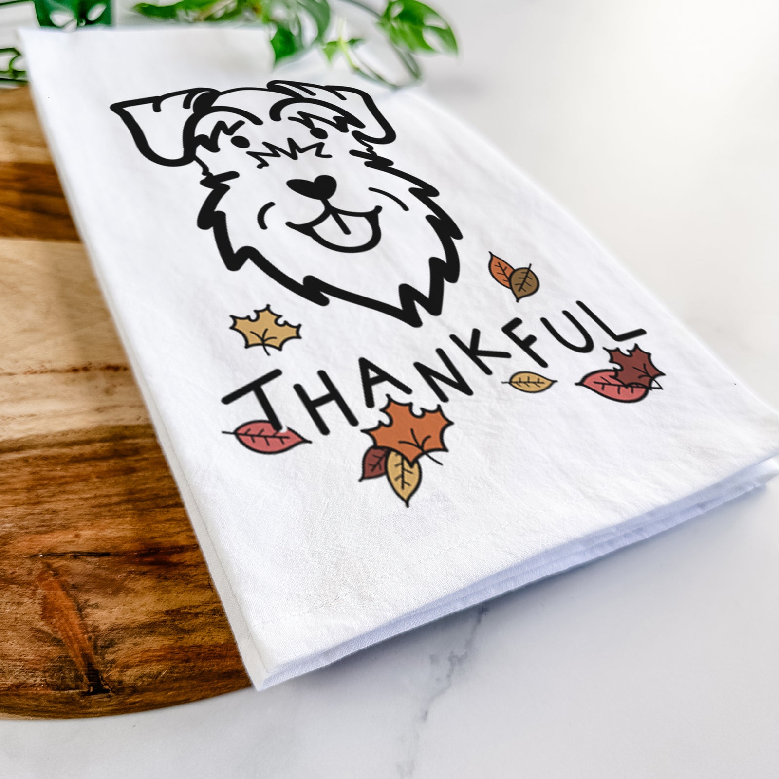 Minimalist line drawing of a Schnauzer Natural Ears with 'Thankful' lettering on a tea towel