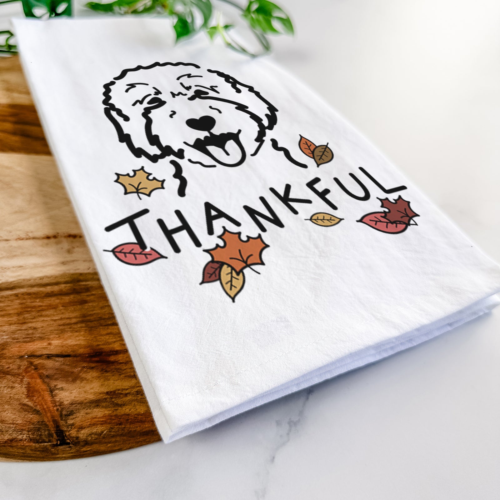 Minimalist line drawing of a Goldendoodle 2 with 'Thankful' lettering on a tea towel