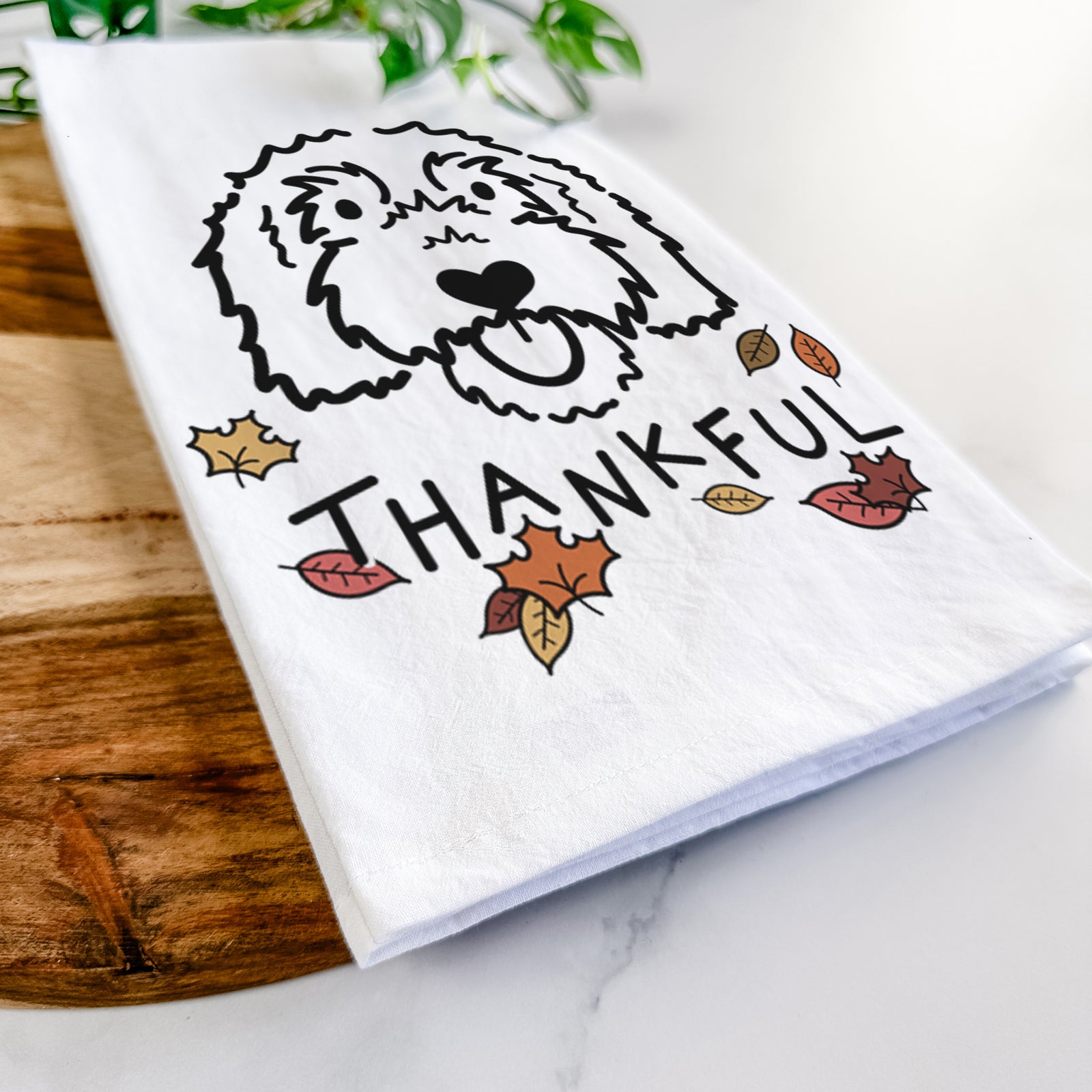 Minimalist line drawing of Gus the Goldendoodle with 'Thankful' lettering on a tea towel