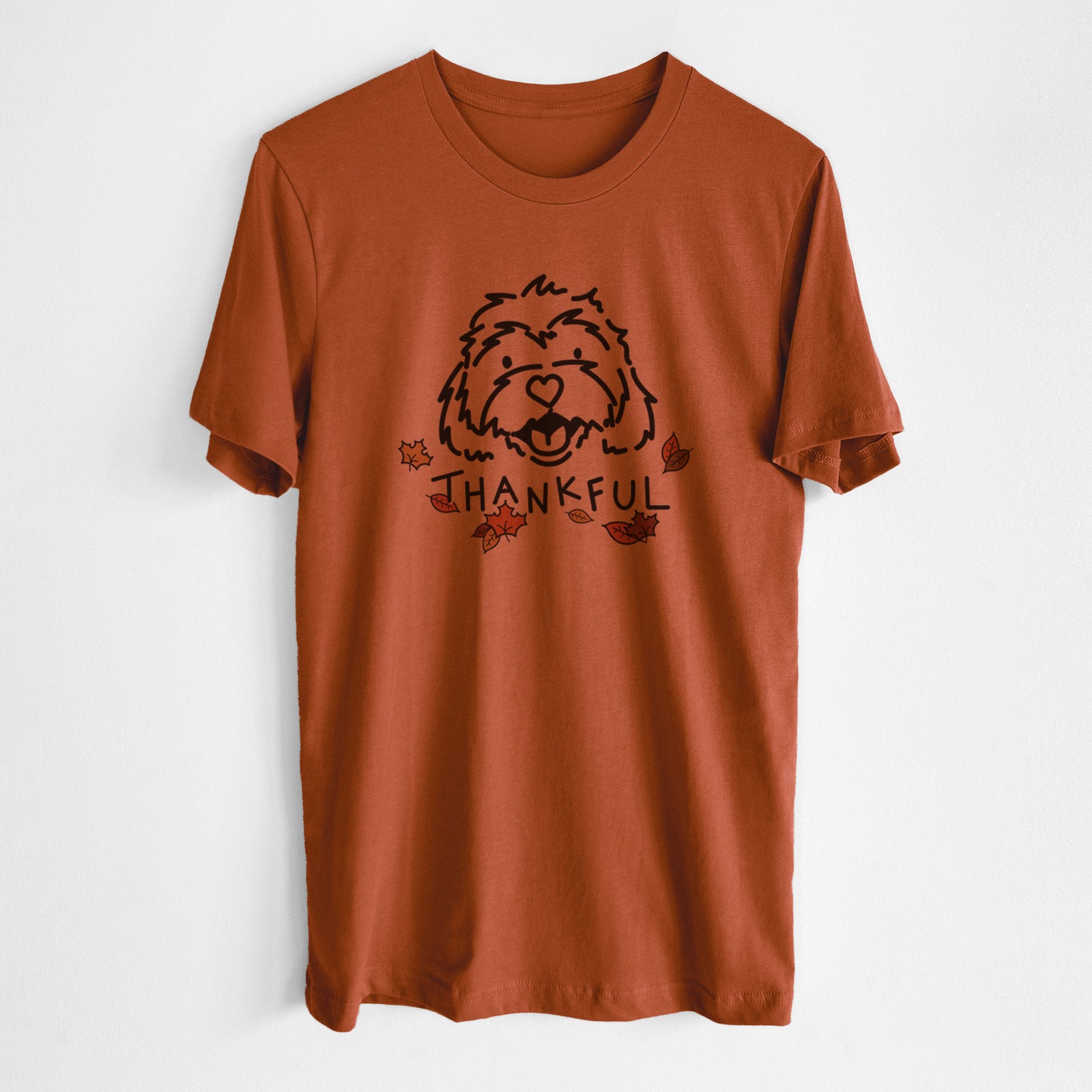 Minimalist line drawing of Harry the Cavachon with 'Thankful' lettering on an Autumn Unisex crewneck, worn by a man