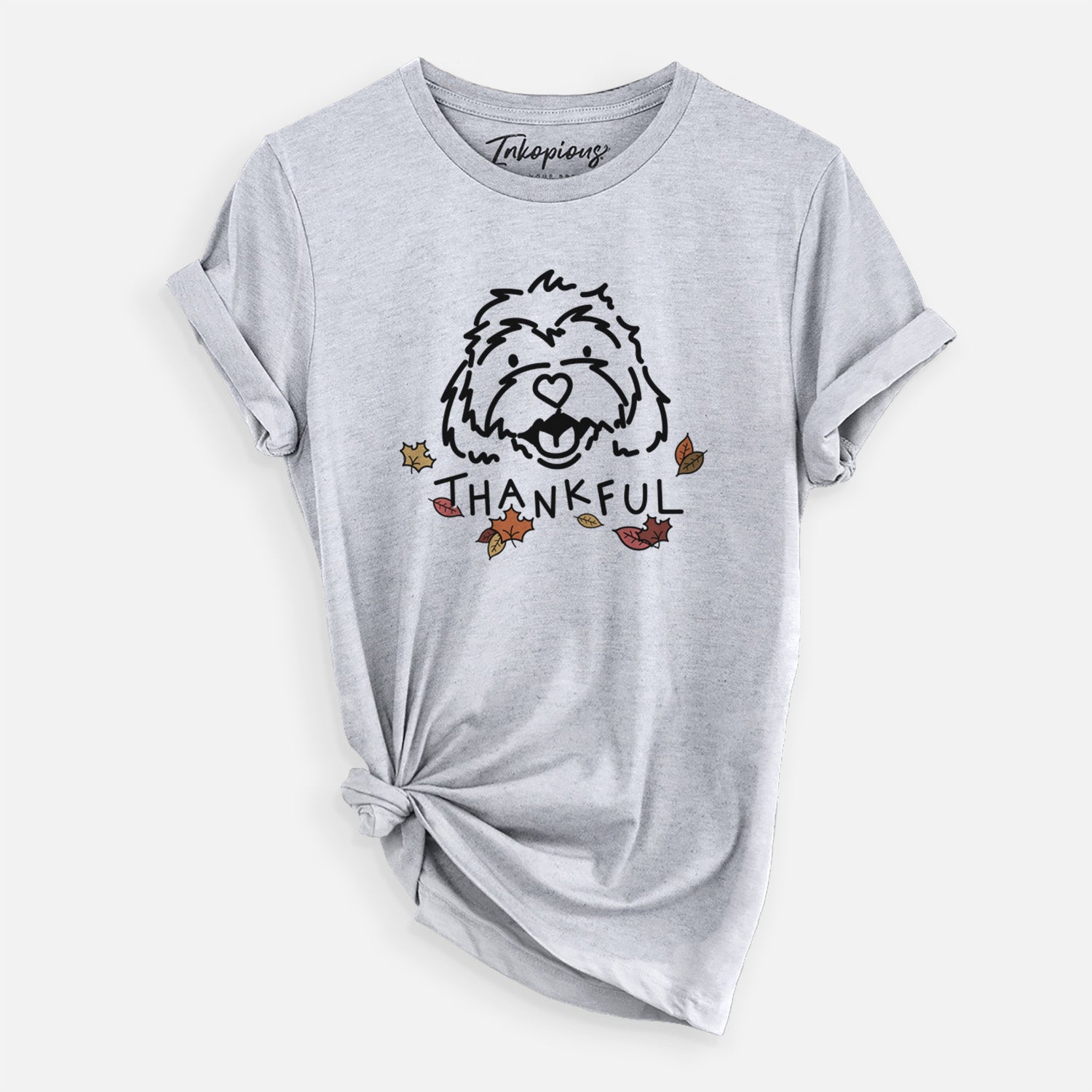 Minimalist line drawing of Harry the Cavachon with 'Thankful' lettering on a Grey Unisex crewneck, worn by a woman