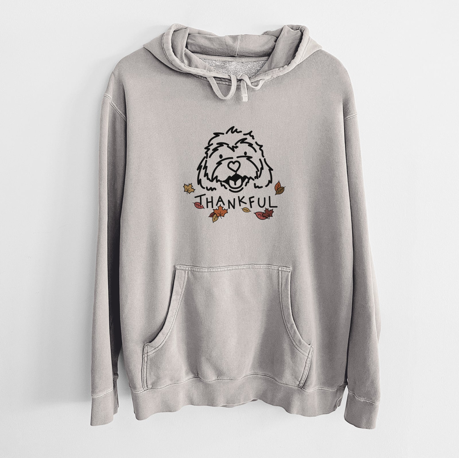 Minimalist line drawing of Harry the Cavachon with 'Thankful' lettering on a Cement Unisex pigment dyed hoodie