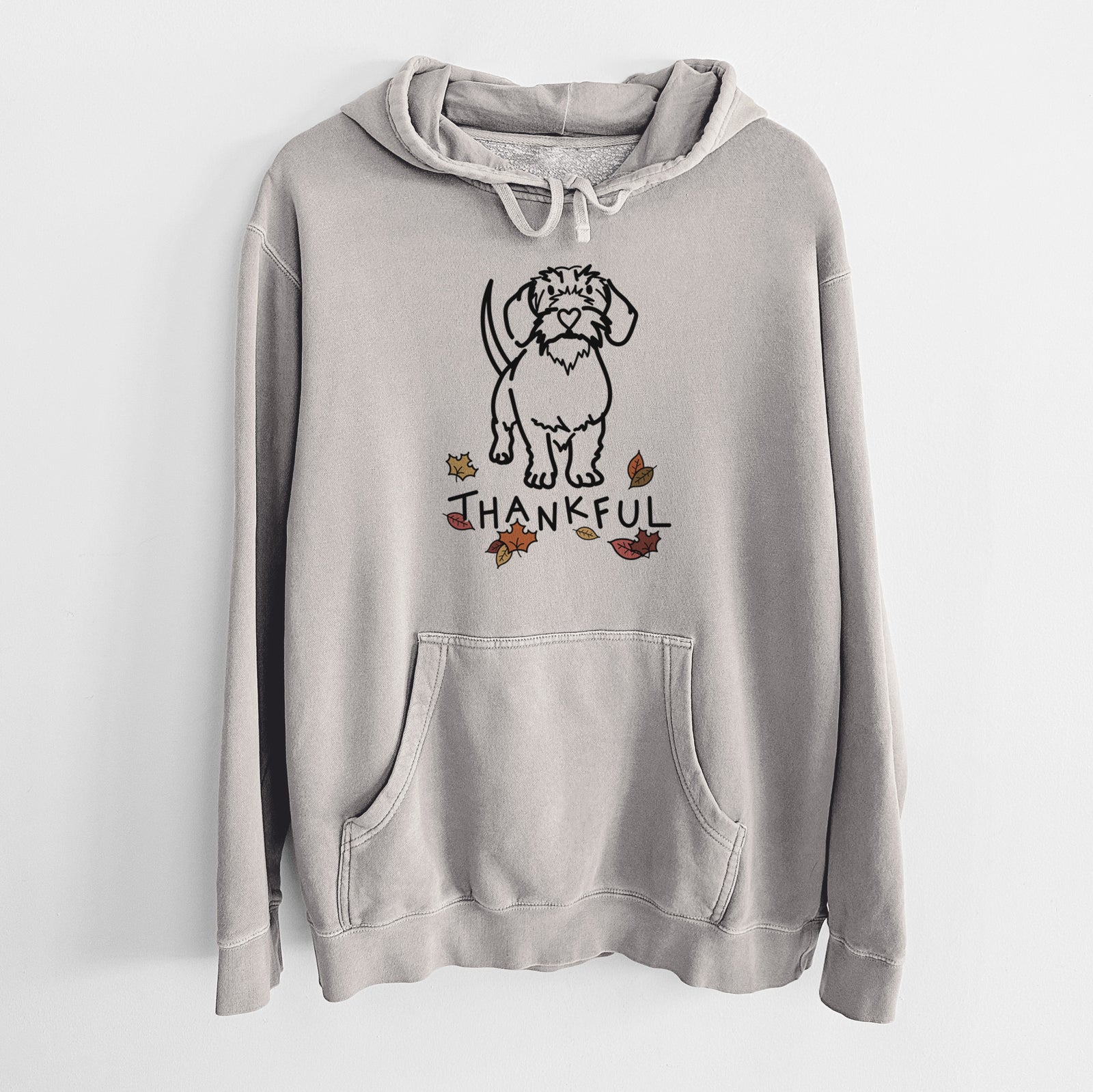 Minimalist line drawing of Henry the Wire Dachshund with 'Thankful' lettering on a Cement Unisex pigment dyed hoodie