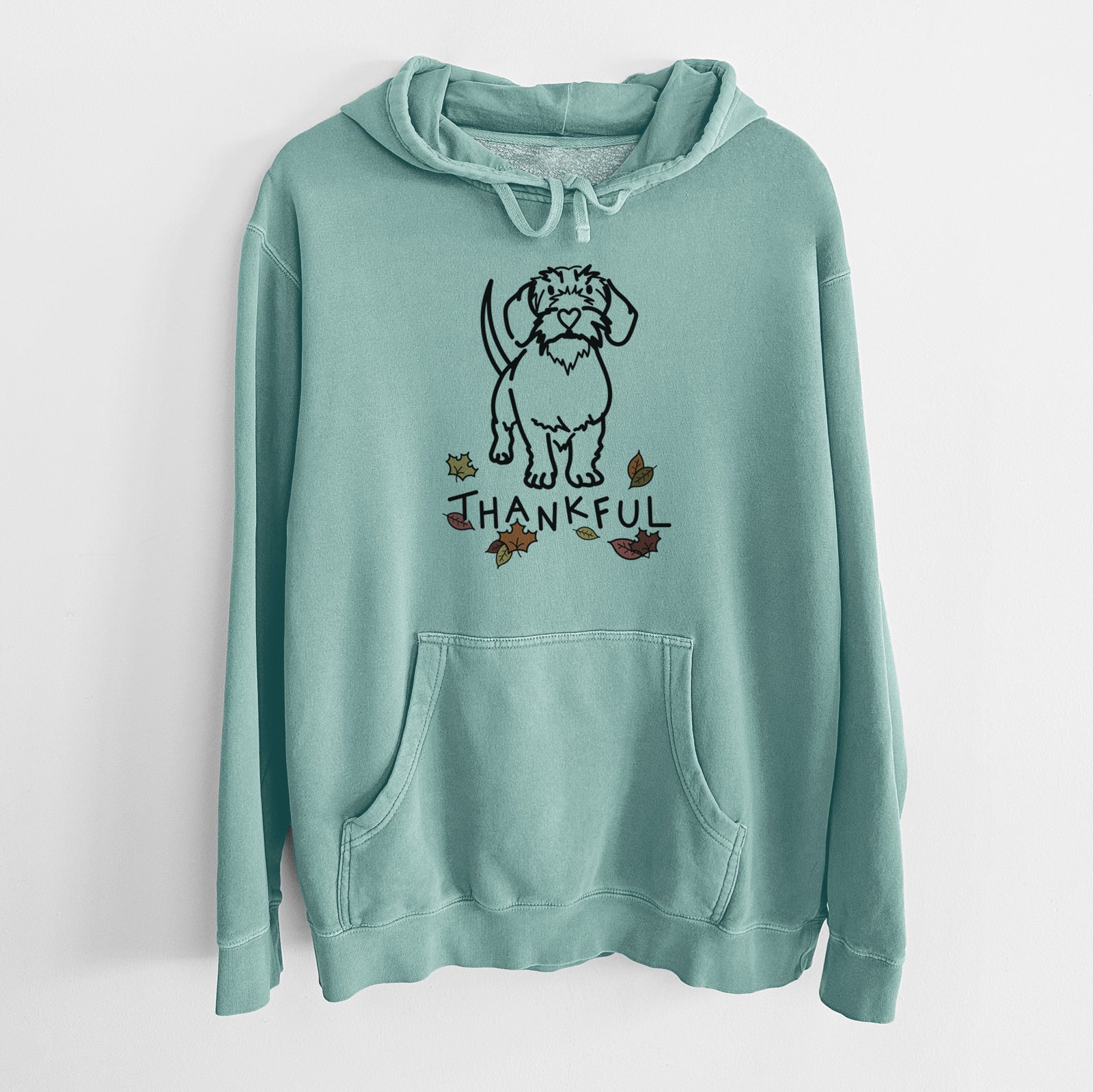 Minimalist line drawing of Henry the Wire Dachshund with 'Thankful' lettering on a Mint Unisex pigment dyed hoodie