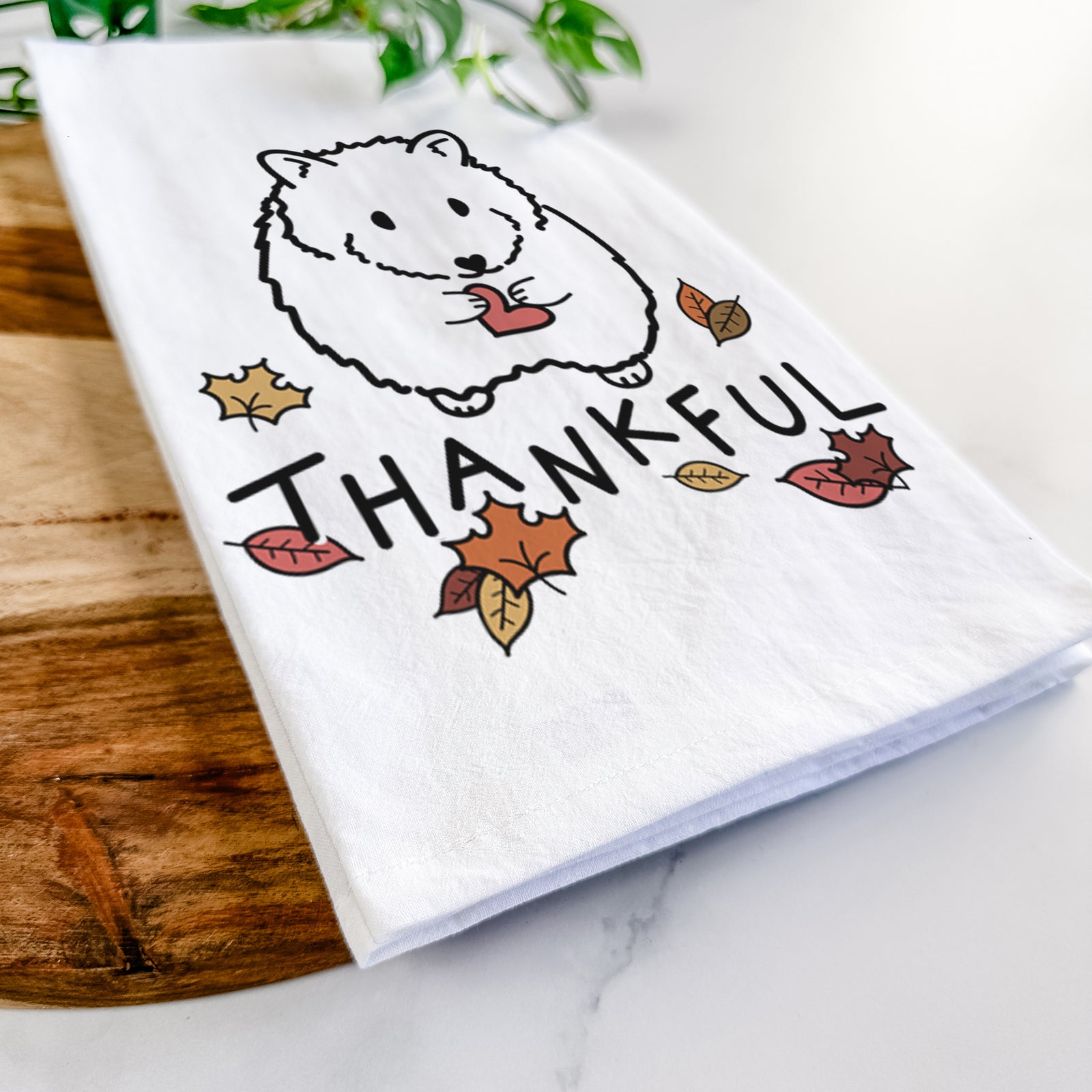 Minimalist line drawing of Hilga the Hamster with 'Thankful' lettering on a tea towel