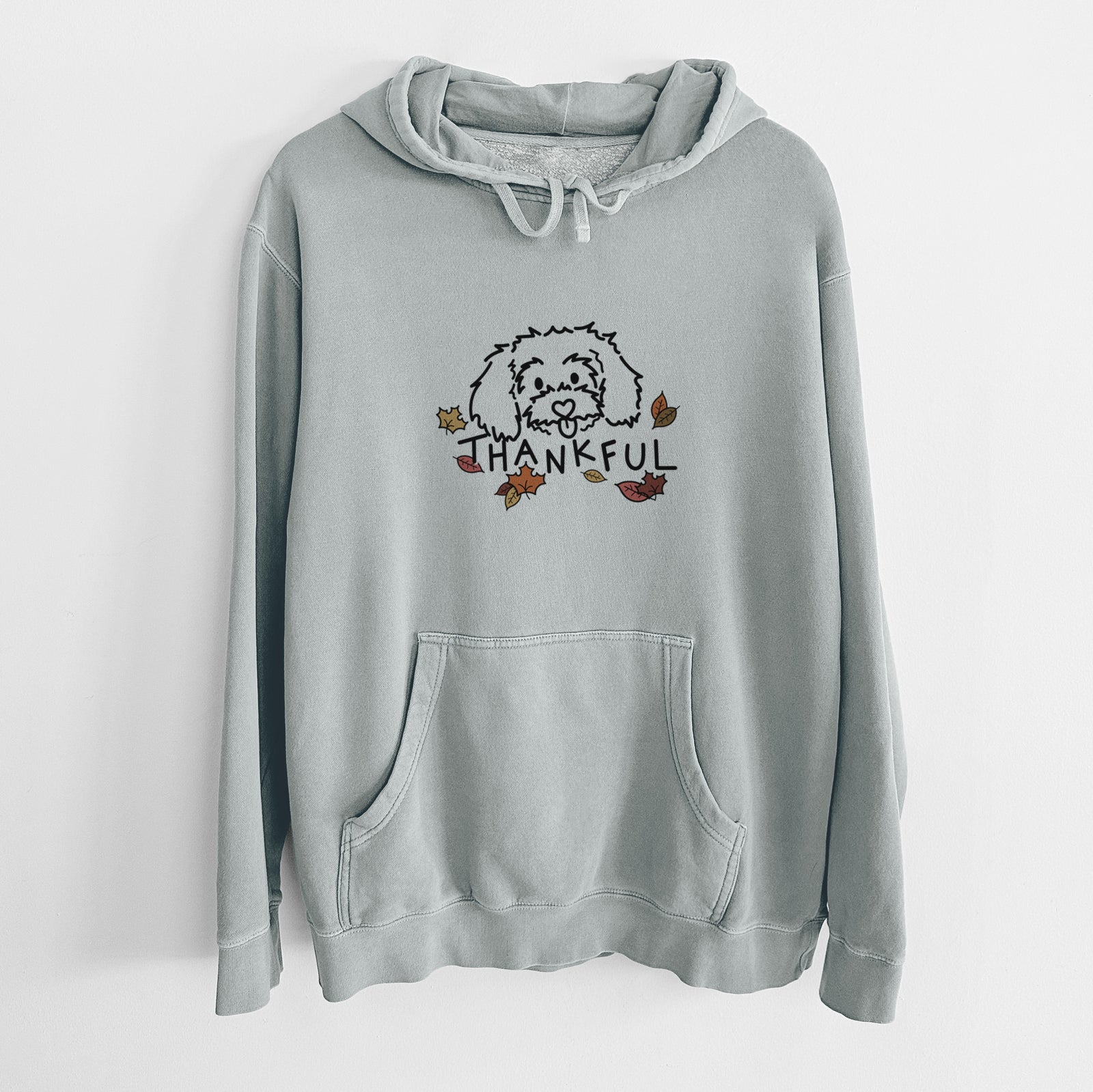 Minimalist line drawing of Holly the Maltipoo with 'Thankful' lettering on a Sage Unisex pigment dyed hoodie