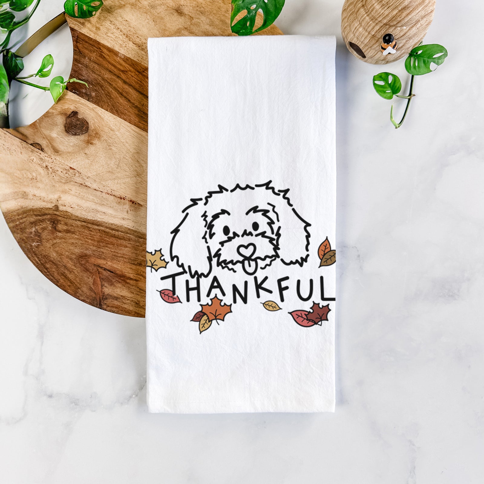 Minimalist line drawing of Holly the Maltipoo with 'Thankful' lettering on a tea towel