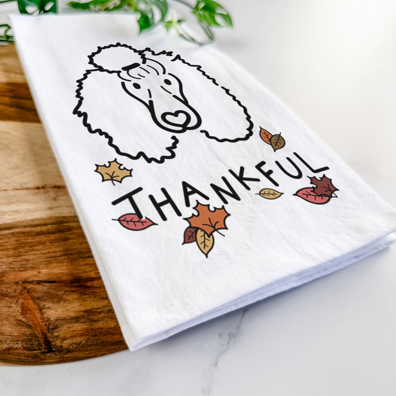 Minimalist line drawing of Jemma the Standard Poodle with 'Thankful' lettering on a tea towel
