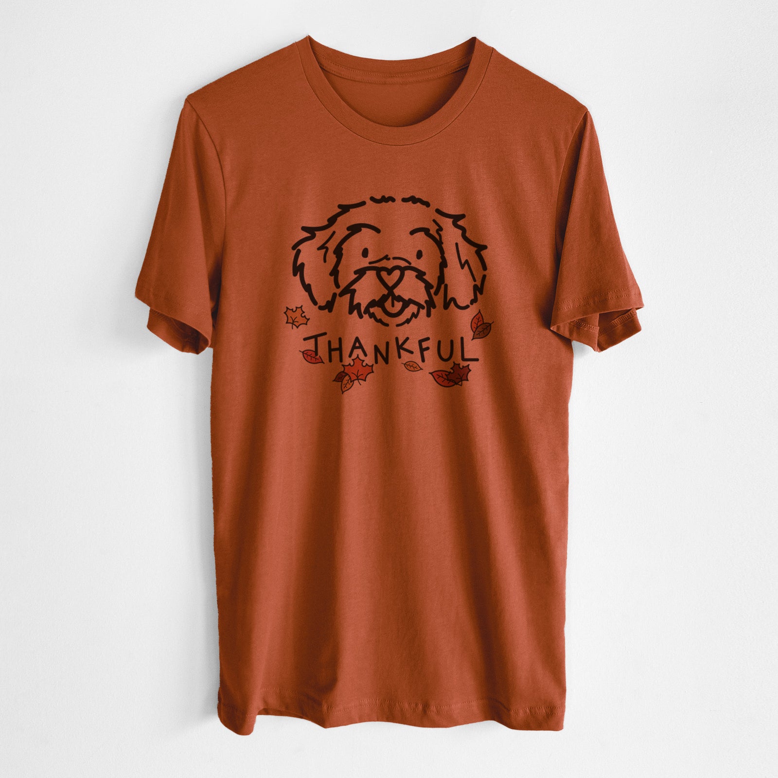 Minimalist line drawing of Jo Jo the Peekapoo with 'Thankful' lettering on an Autumn Unisex crewneck, worn by a man