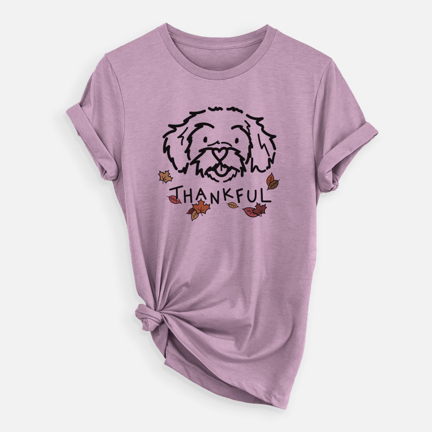 Minimalist line drawing of Jo Jo the Peekapoo with 'Thankful' lettering on an Orchid Unisex crewneck, worn by a woman