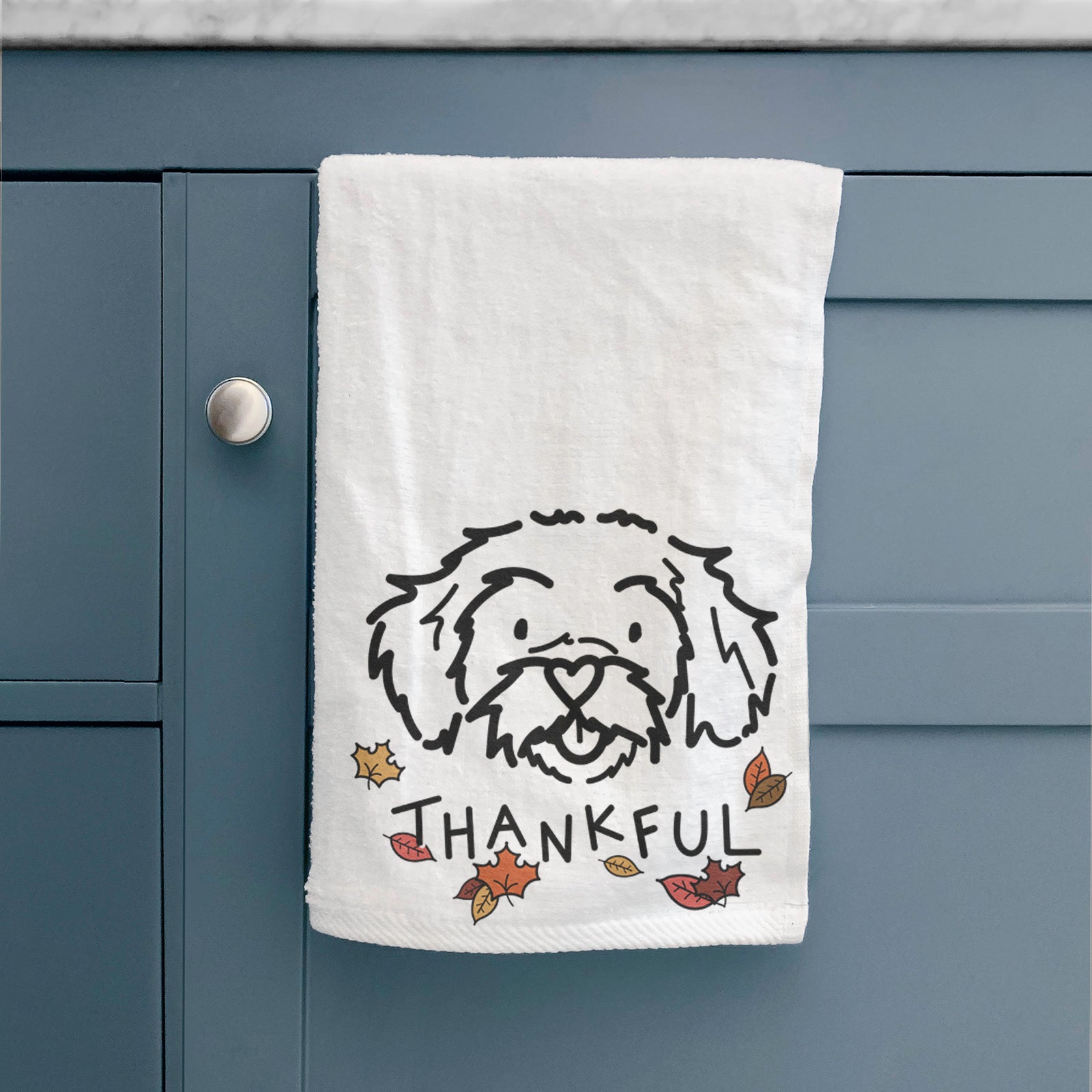 Minimalist line drawing of Jo Jo the Peekapoo with 'Thankful' lettering on a hand towel