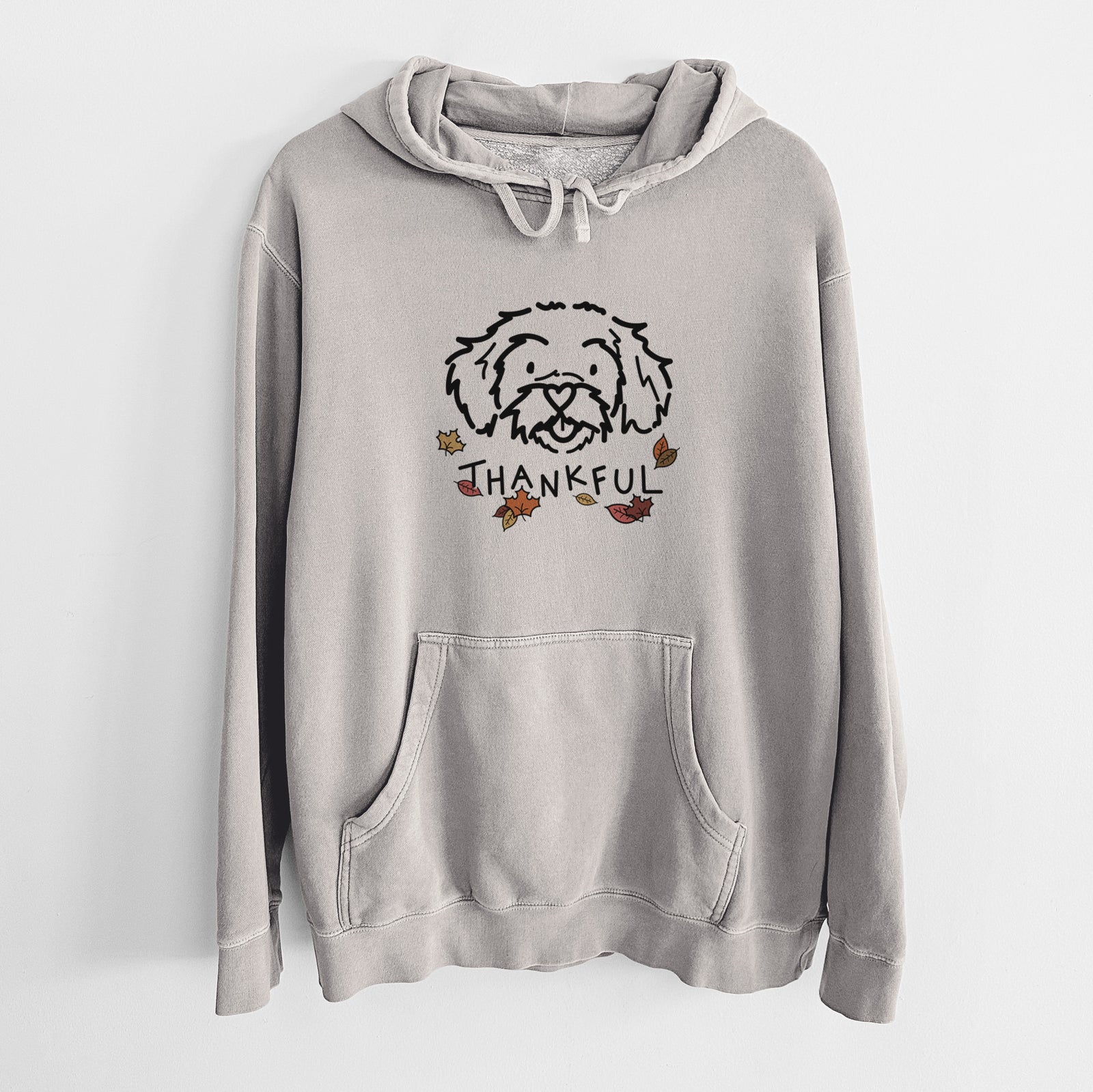 Minimalist line drawing of Jo Jo the Peekapoo with 'Thankful' lettering on a Cement Unisex pigment dyed hoodie