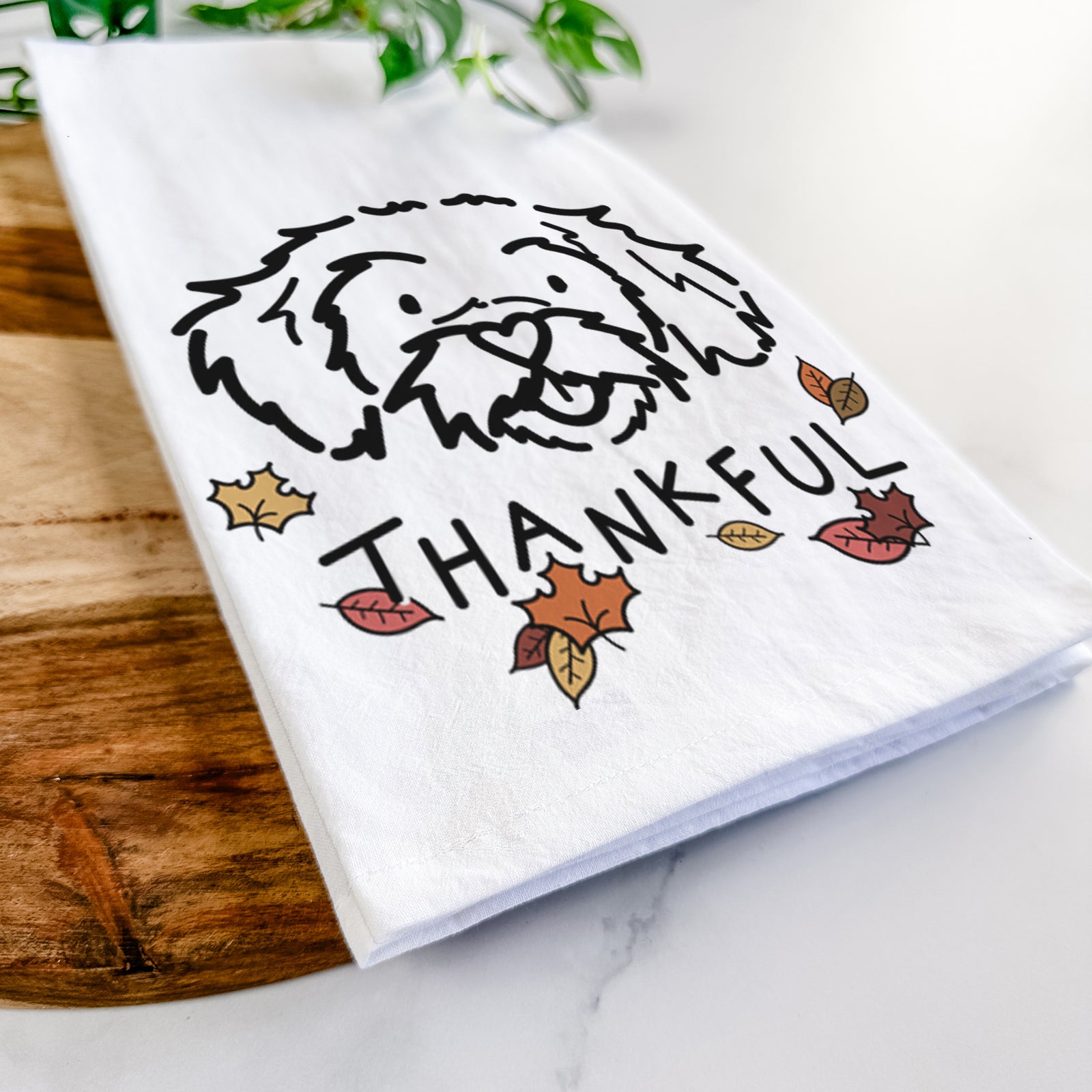 Minimalist line drawing of Jo Jo the Peekapoo with 'Thankful' lettering on a tea towel