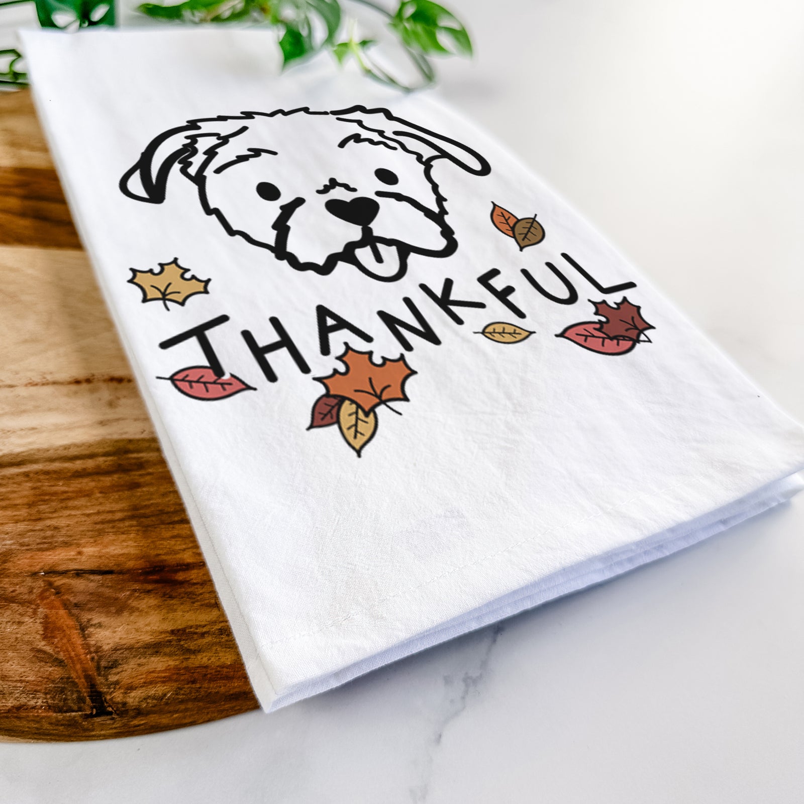 Minimalist line drawing of Koko the Shih Tzu with 'Thankful' lettering on a tea towel