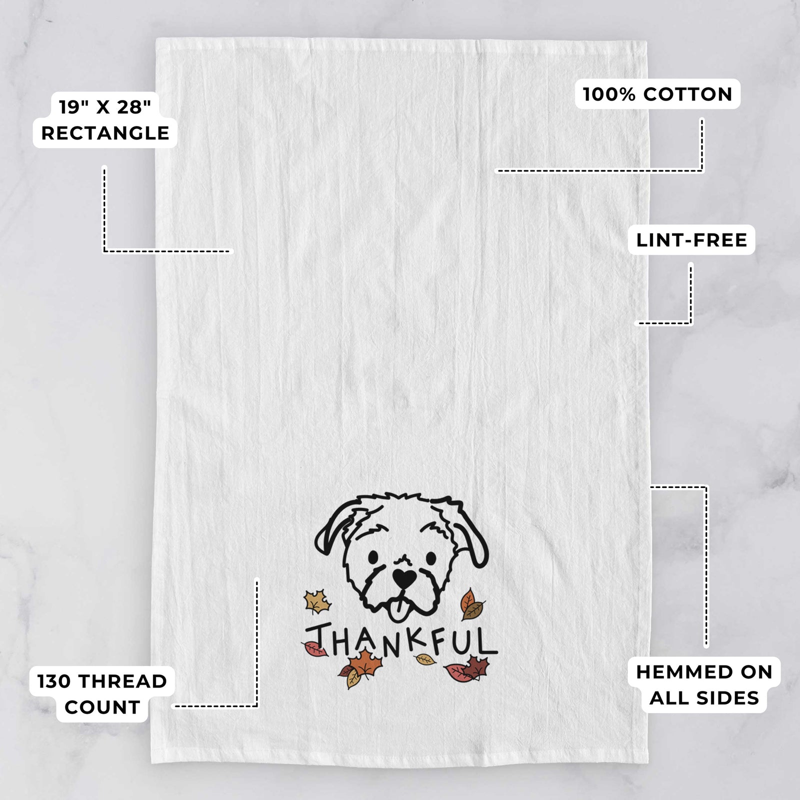 Minimalist line drawing of Koko the Shih Tzu with 'Thankful' lettering on a tea towel, with feature callouts: 19 x 28 inch rectangle, 100% cotton, lint-free, 120 thread count, hemmed on all sides