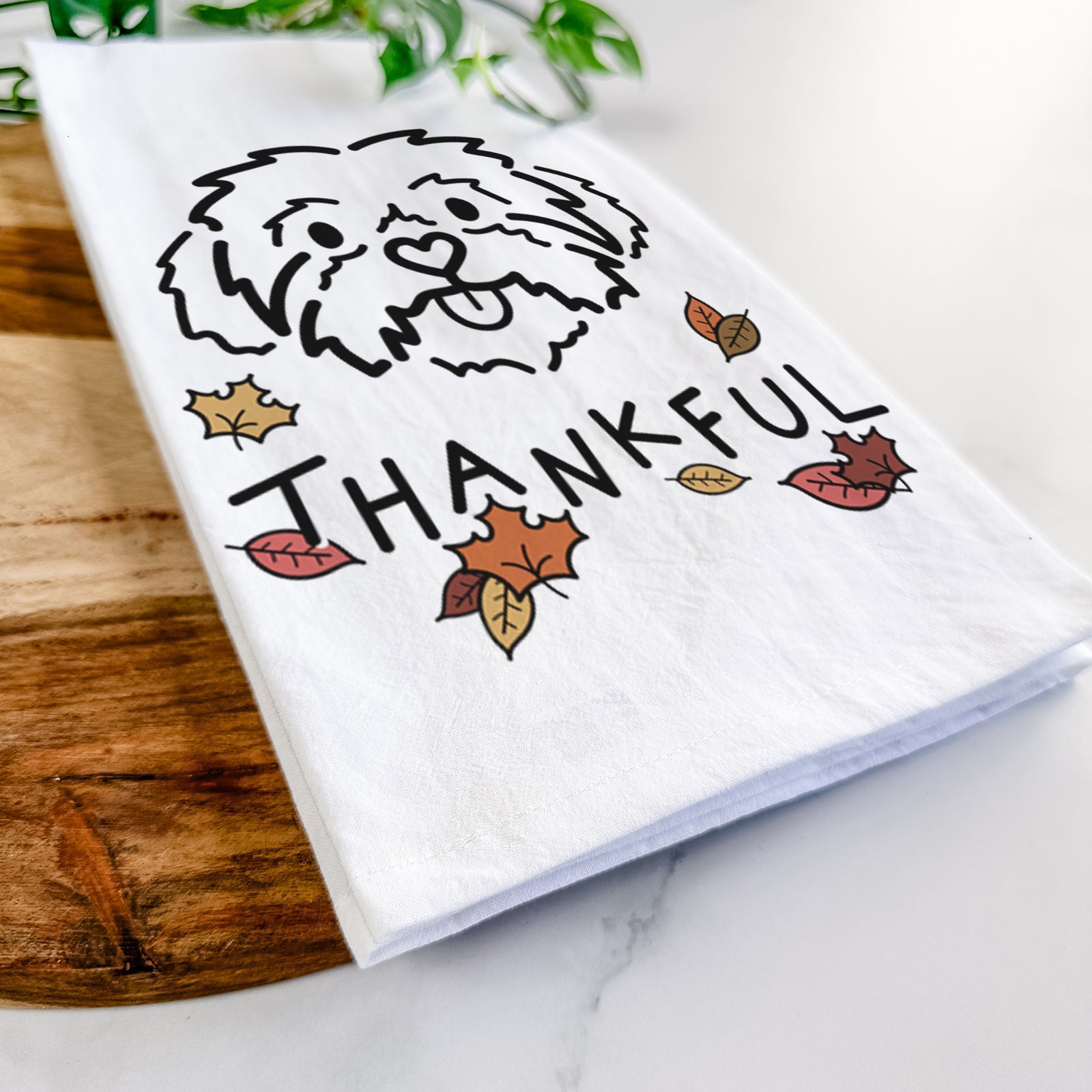 Minimalist line drawing of Leo the Shih Tzu with 'Thankful' lettering on a tea towel