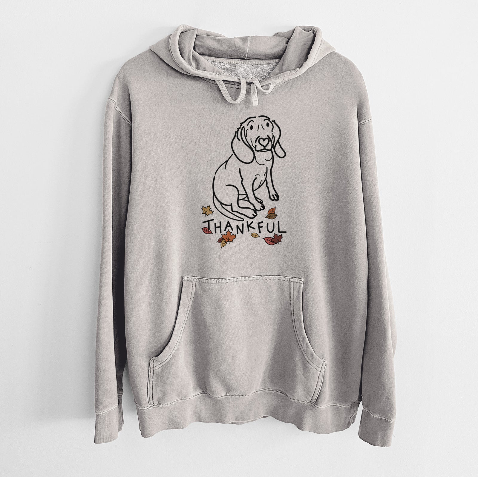 Minimalist line drawing of Lilly the Beagle with 'Thankful' lettering on a Cement Unisex pigment dyed hoodie