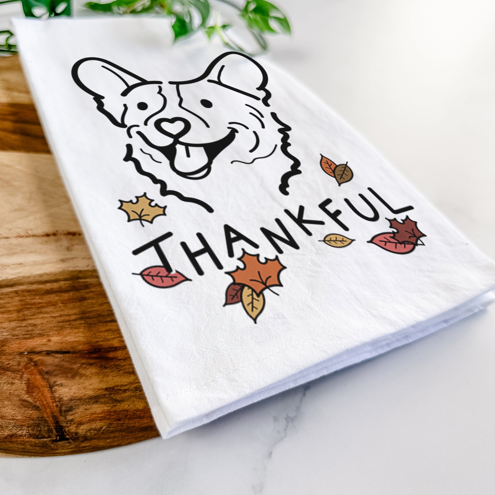 Minimalist line drawing of Lily the Corgi with 'Thankful' lettering on a tea towel