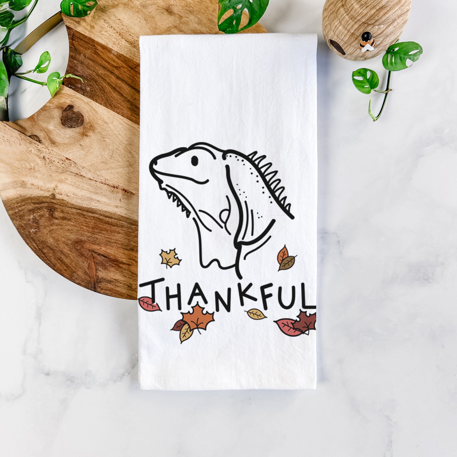 Minimalist line drawing of Louie the Iguana with 'Thankful' lettering on a tea towel