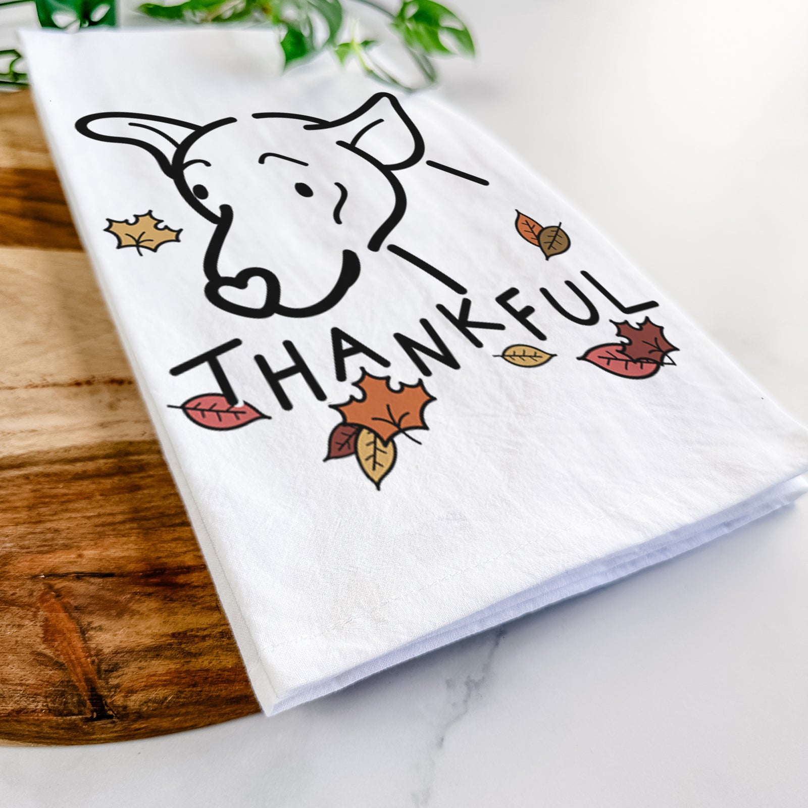 Minimalist line drawing of Lucky the Mixed Breed with 'Thankful' lettering on a tea towel