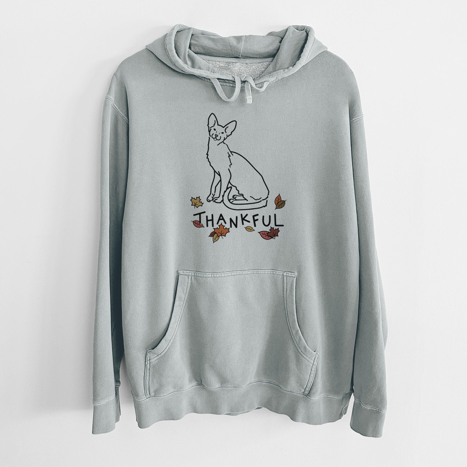 Minimalist line drawing of Lyra the Oriental Shorthair Cat with 'Thankful' lettering on a Sage Unisex pigment dyed hoodie