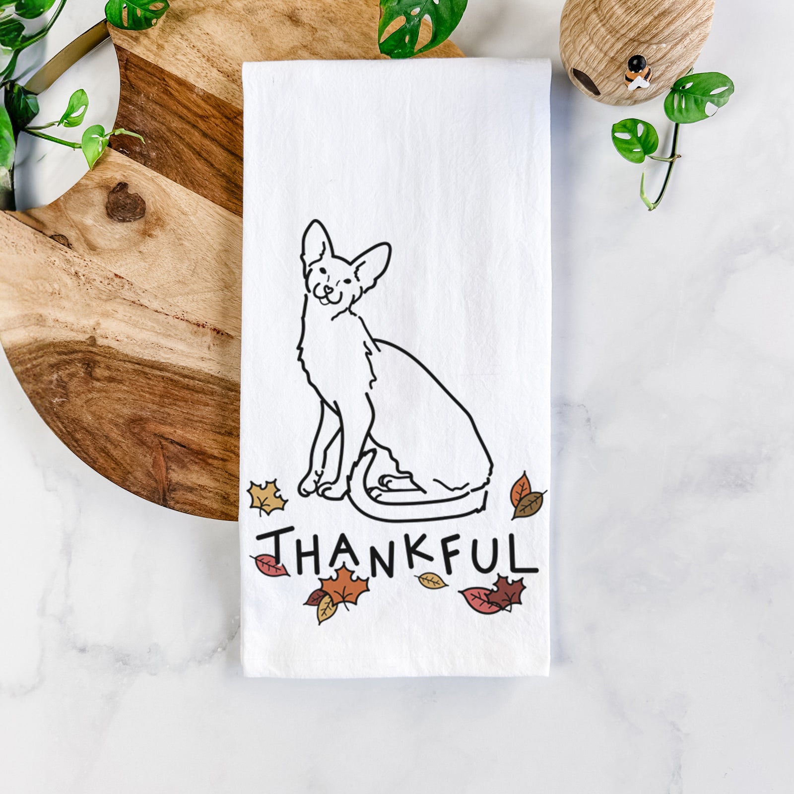 Minimalist line drawing of Lyra the Oriental Shorthair Cat with 'Thankful' lettering on a tea towel