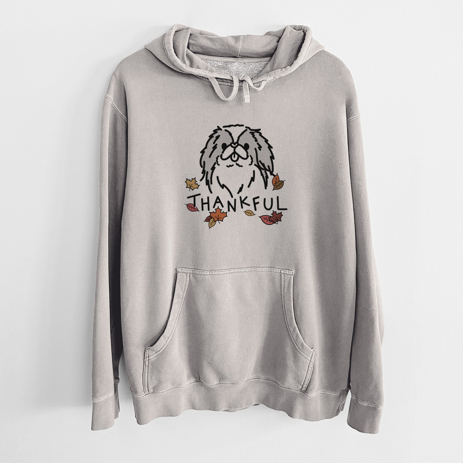 Minimalist line drawing of Macha the Japanese Chin with 'Thankful' lettering on a Cement Unisex pigment dyed hoodie