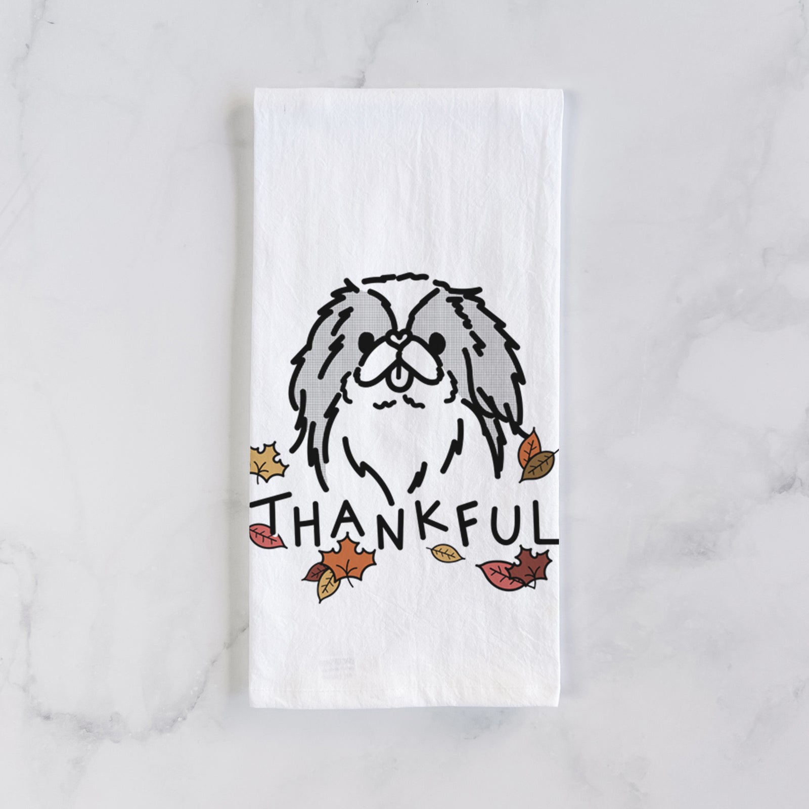Minimalist line drawing of Macha the Japanese Chin with 'Thankful' lettering on a tea towel