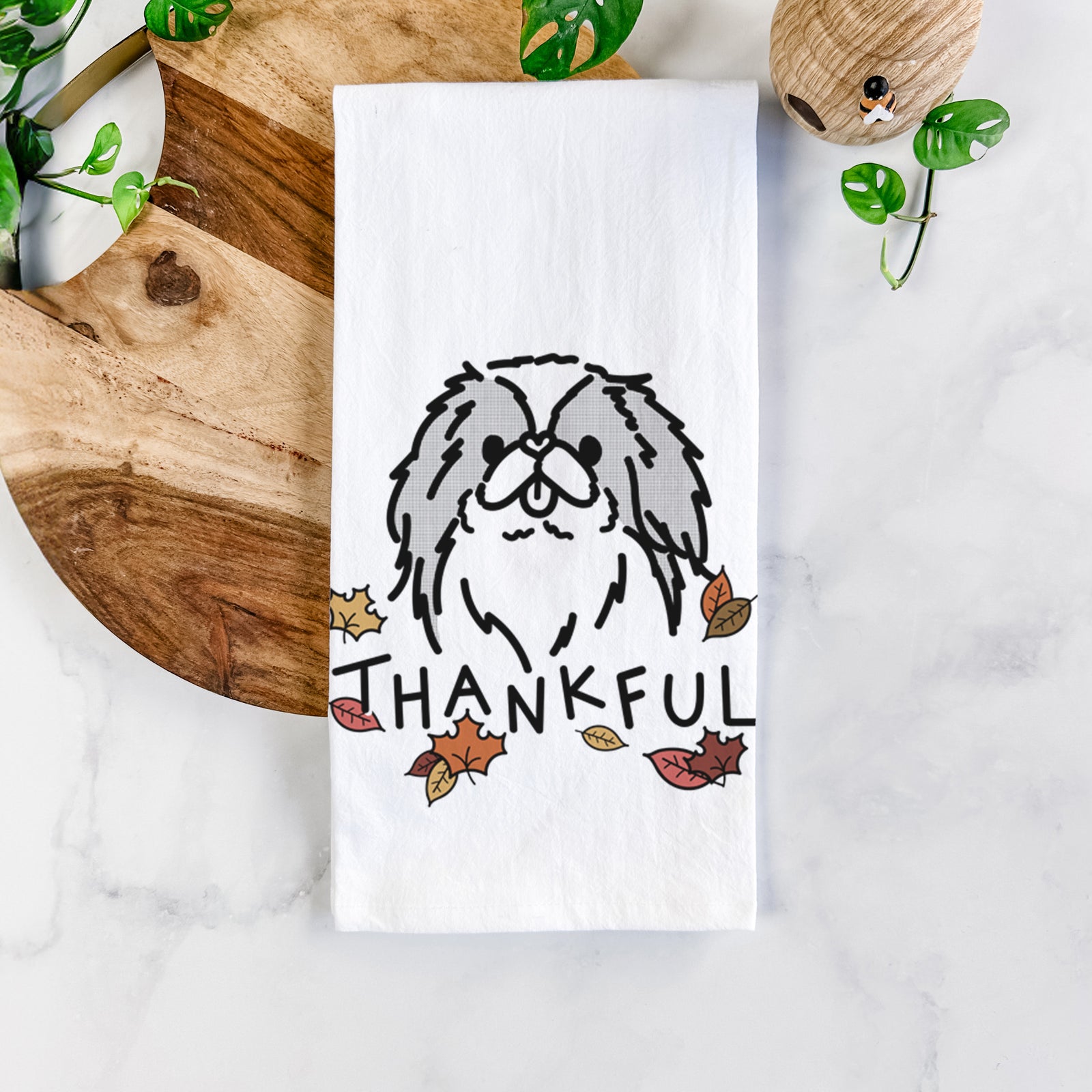 Minimalist line drawing of Macha the Japanese Chin with 'Thankful' lettering on a tea towel