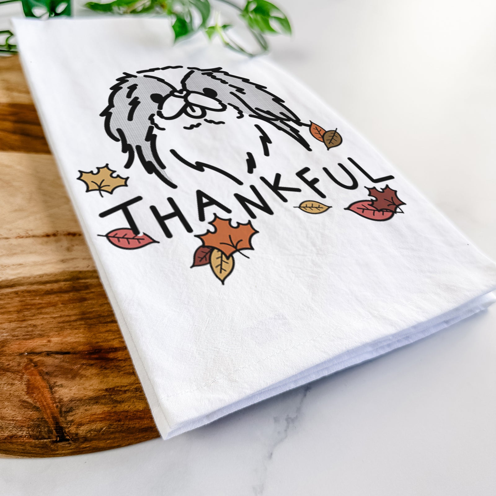 Minimalist line drawing of Macha the Japanese Chin with 'Thankful' lettering on a tea towel