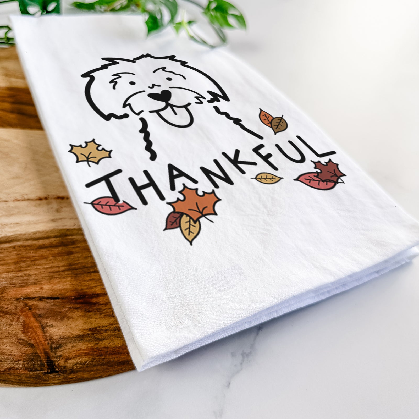 Minimalist line drawing of a Maltese with 'Thankful' lettering on a tea towel