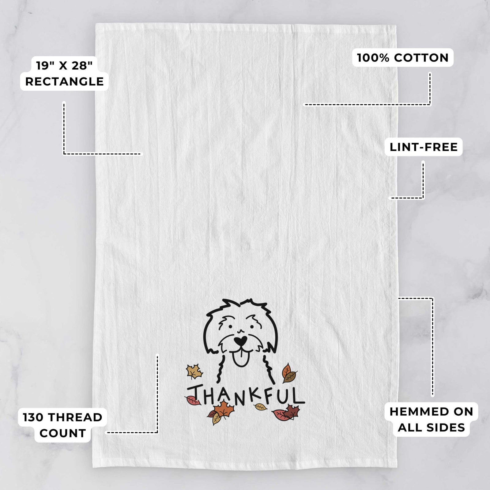 Minimalist line drawing of a Maltese with 'Thankful' lettering on a tea towel, with feature callouts: 19 x 28 inch rectangle, 100% cotton, lint-free, 120 thread count, hemmed on all sides