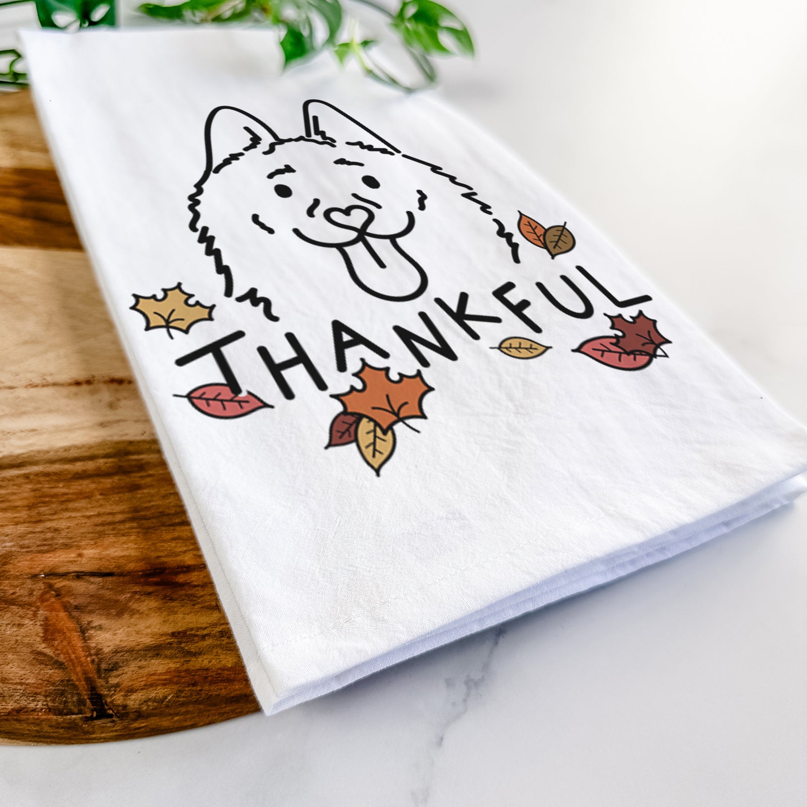 Minimalist line drawing of Meeko the Schipperke with 'Thankful' lettering on a tea towel