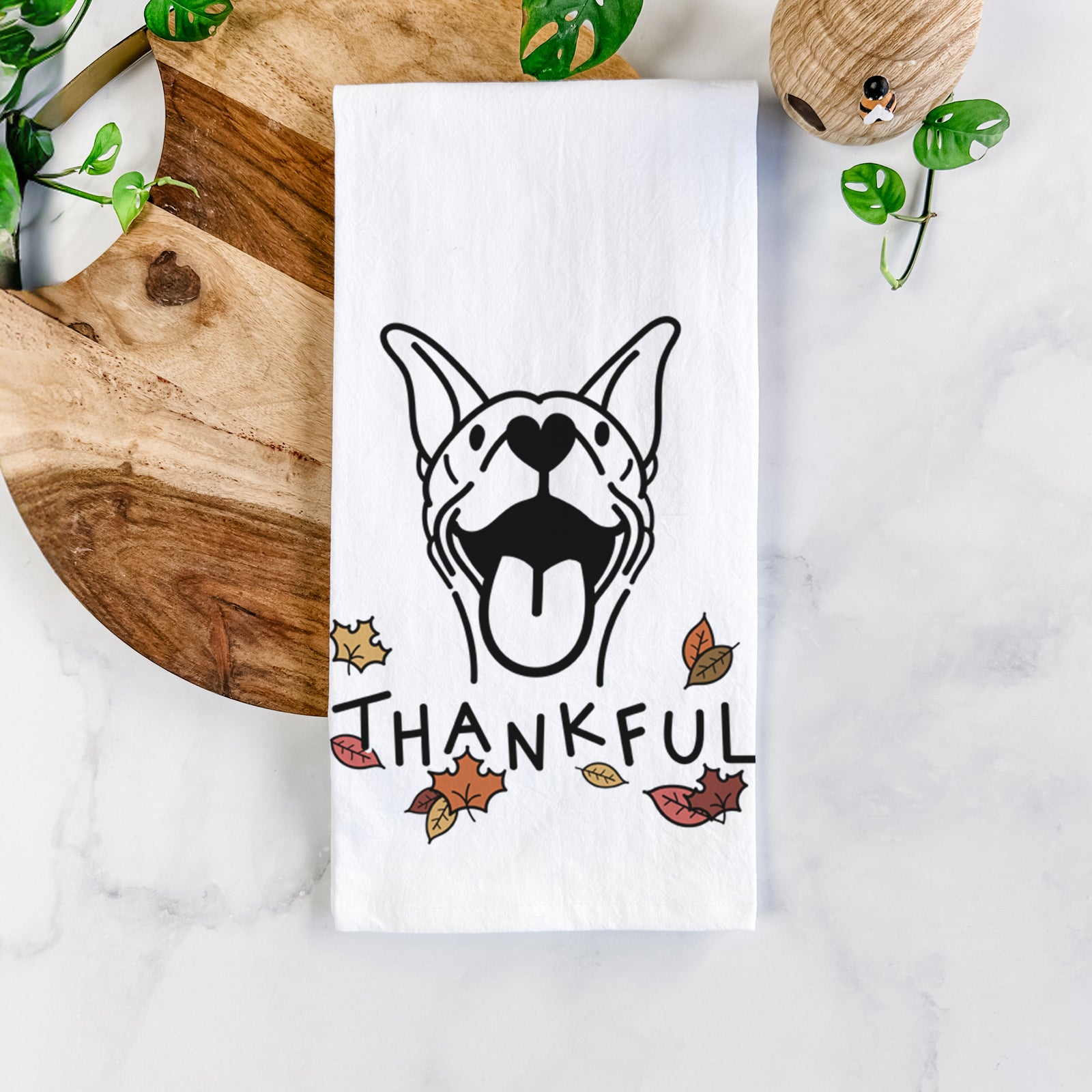 Minimalist line drawing of Merlin the Basenji with 'Thankful' lettering on a tea towel