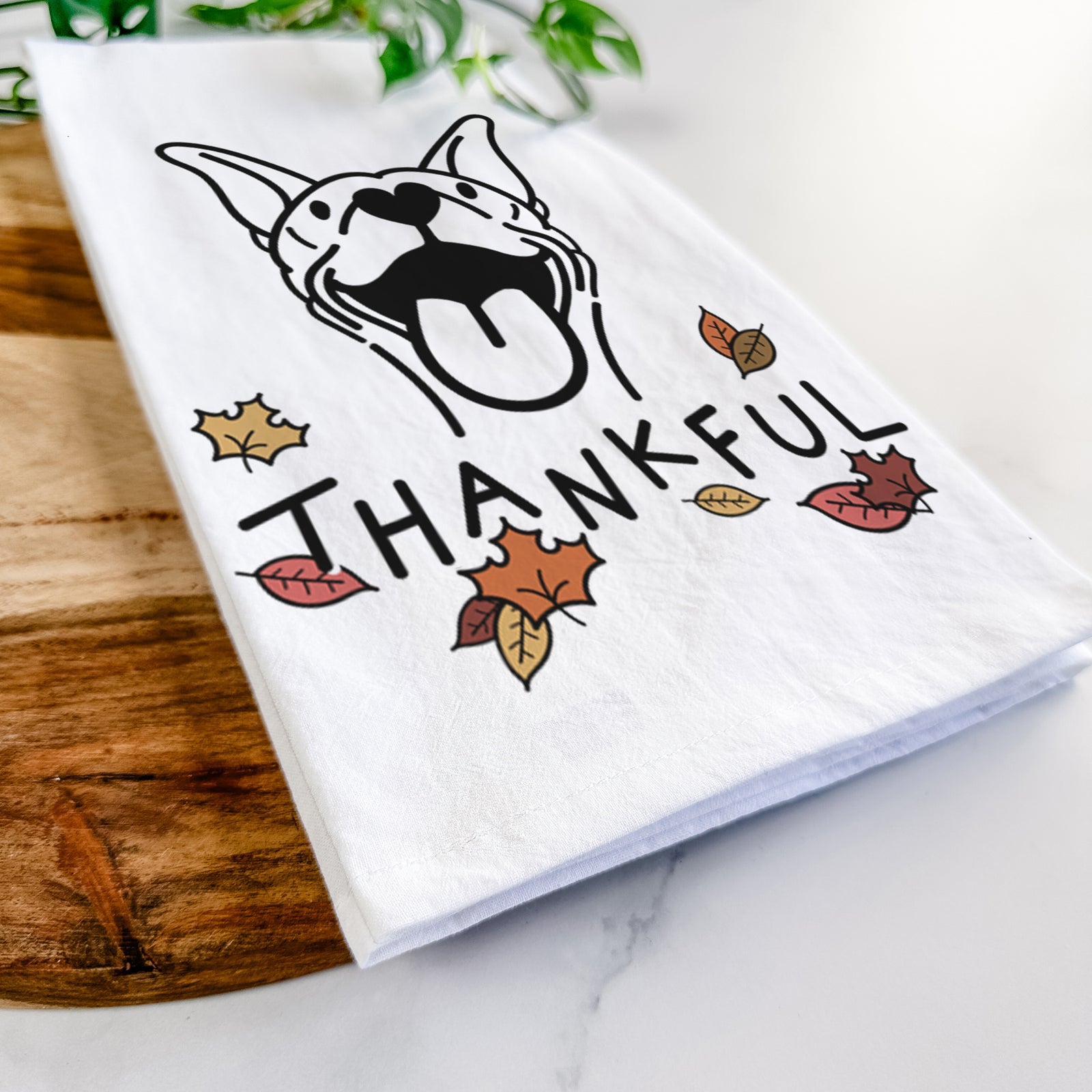 Minimalist line drawing of Merlin the Basenji with 'Thankful' lettering on a tea towel
