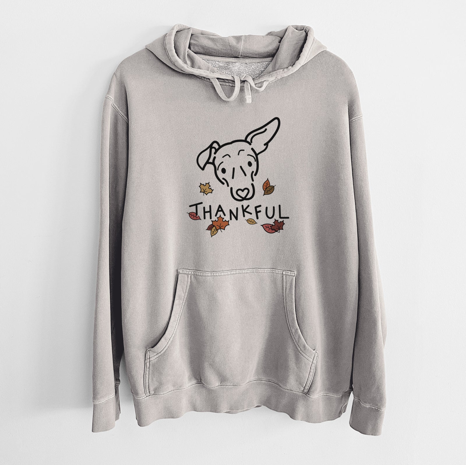 Minimalist line drawing of Millie the Mixed Breed with 'Thankful' lettering on a Cement Unisex pigment dyed hoodie