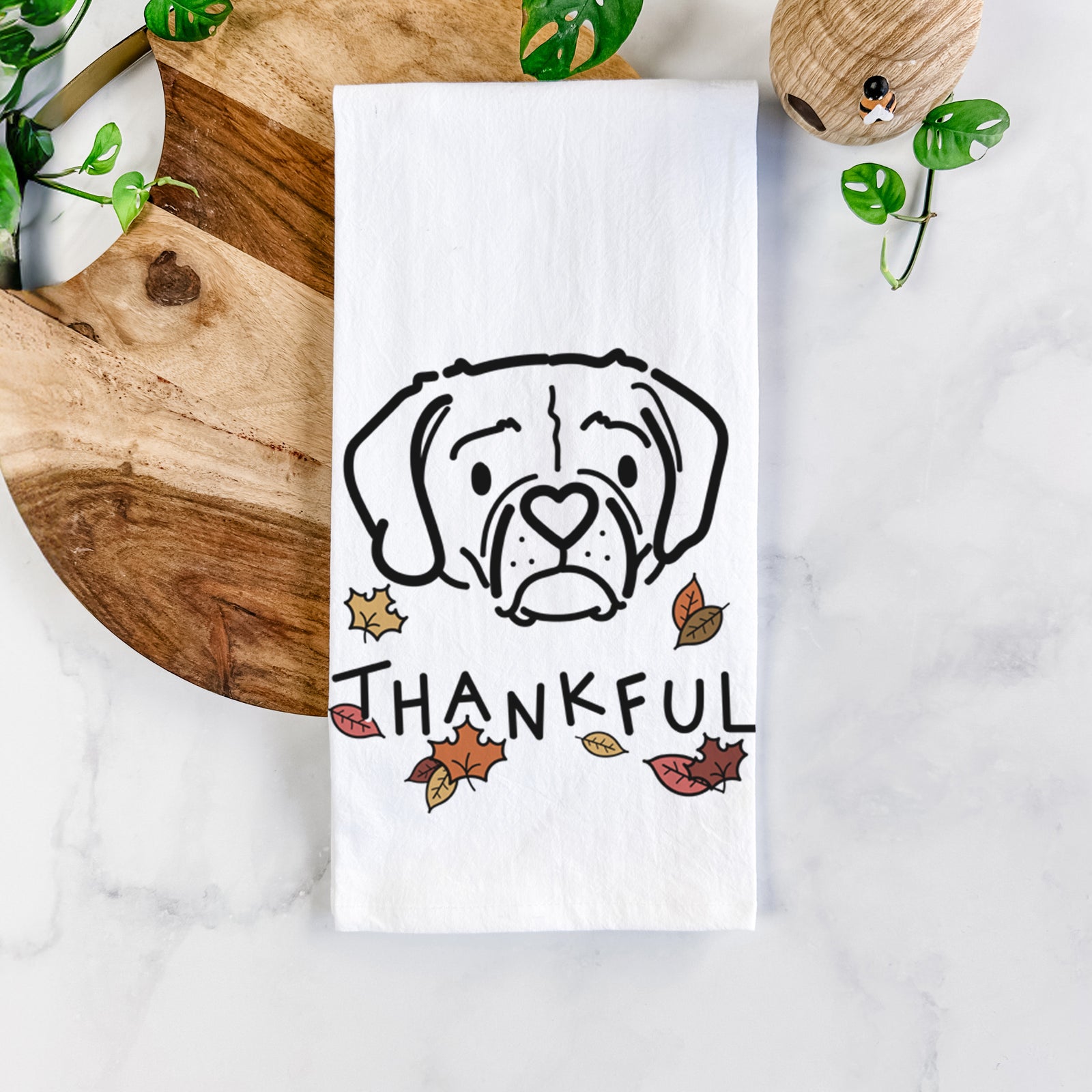 Minimalist line drawing of Mitzi the Puggle with 'Thankful' lettering on a tea towel