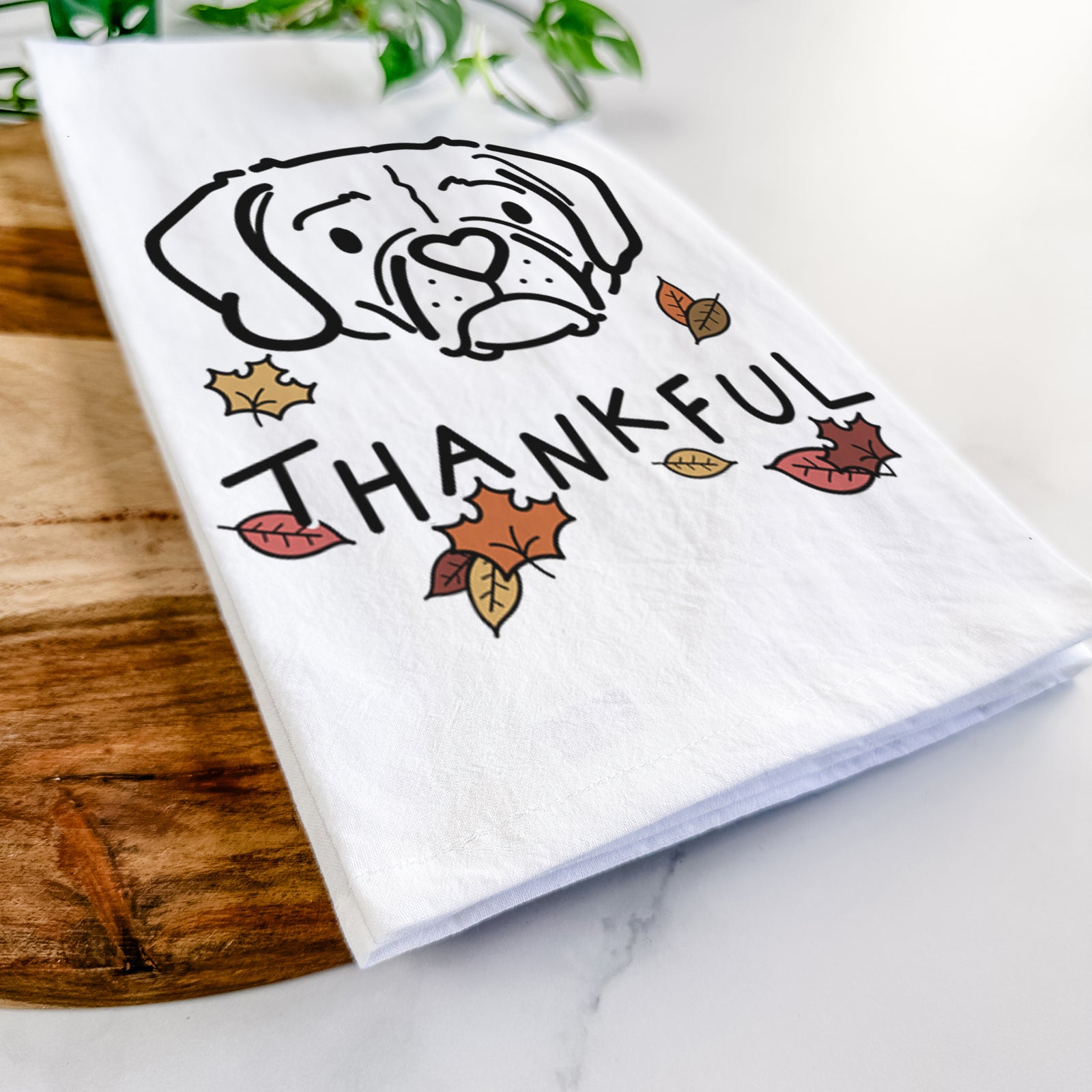 Minimalist line drawing of Mitzi the Puggle with 'Thankful' lettering on a tea towel