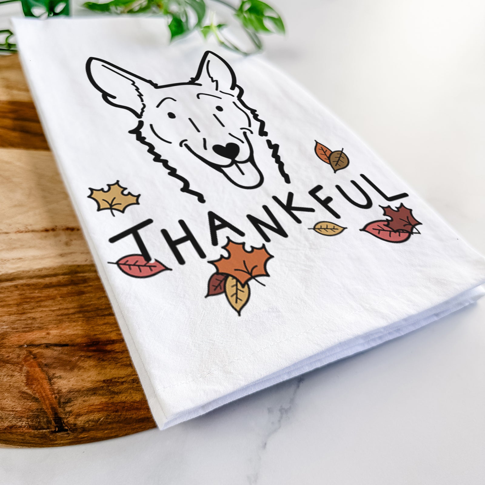 Minimalist line drawing of Mochi the Carolina Dog with 'Thankful' lettering on a tea towel