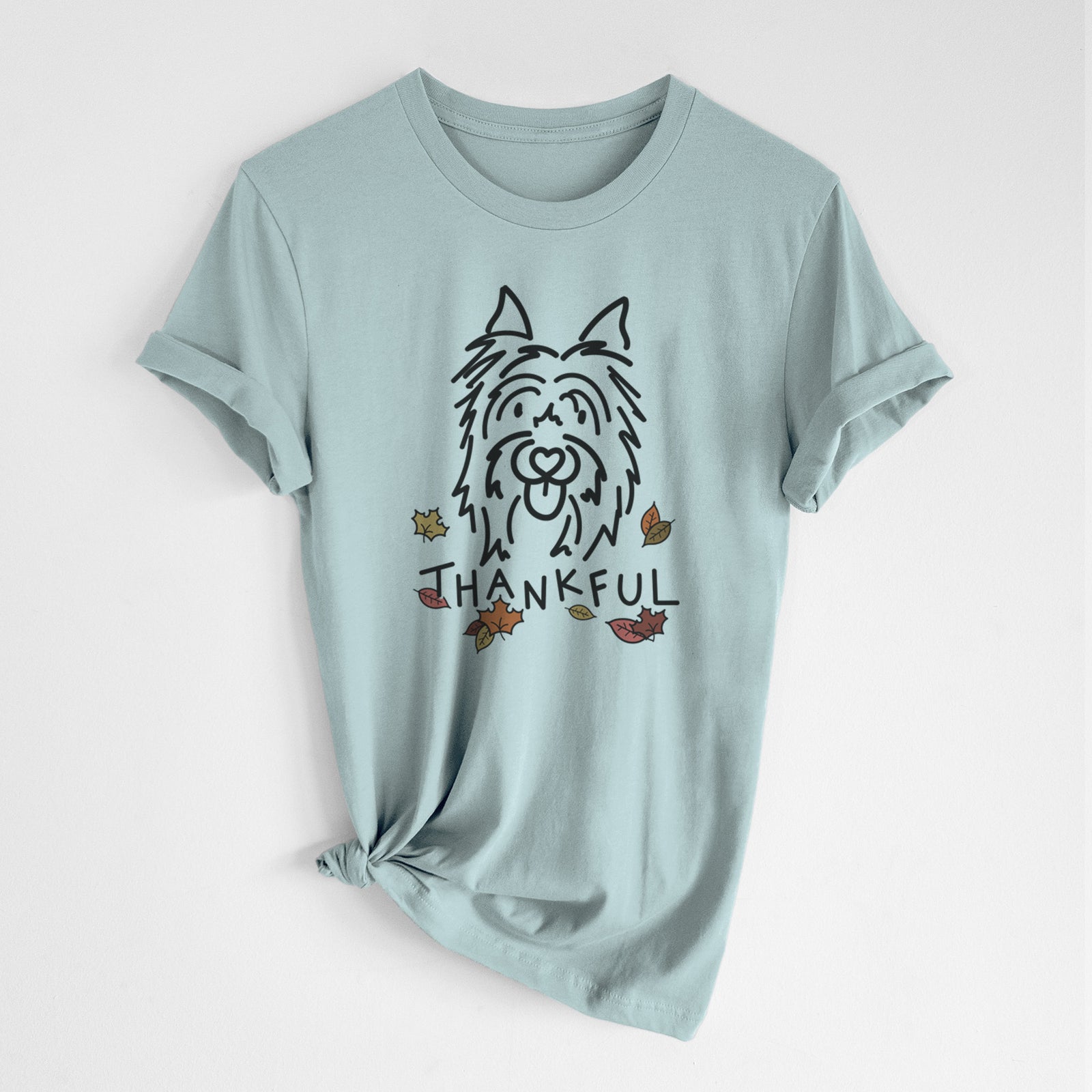 Minimalist line drawing of Monty the Silky Terrier with 'Thankful' lettering on a Dusty Blue Unisex crewneck, worn by a woman