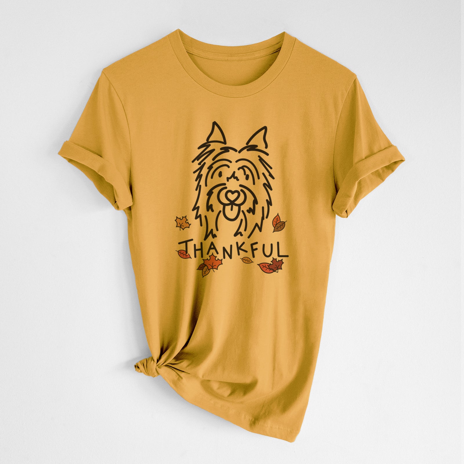 Minimalist line drawing of Monty the Silky Terrier with 'Thankful' lettering on a Honeycomb Unisex crewneck, worn by a woman