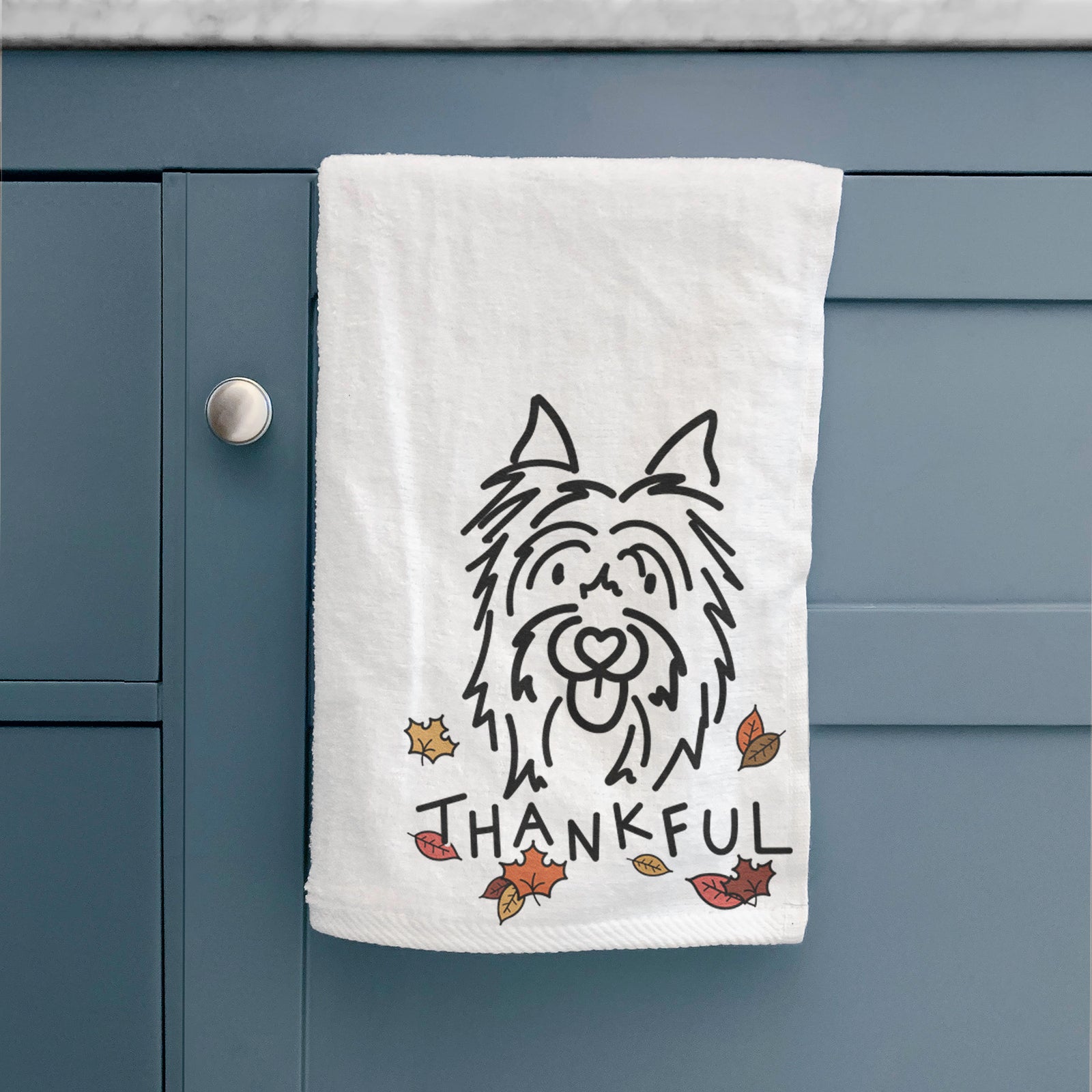 Minimalist line drawing of Monty the Silky Terrier with 'Thankful' lettering on a hand towel