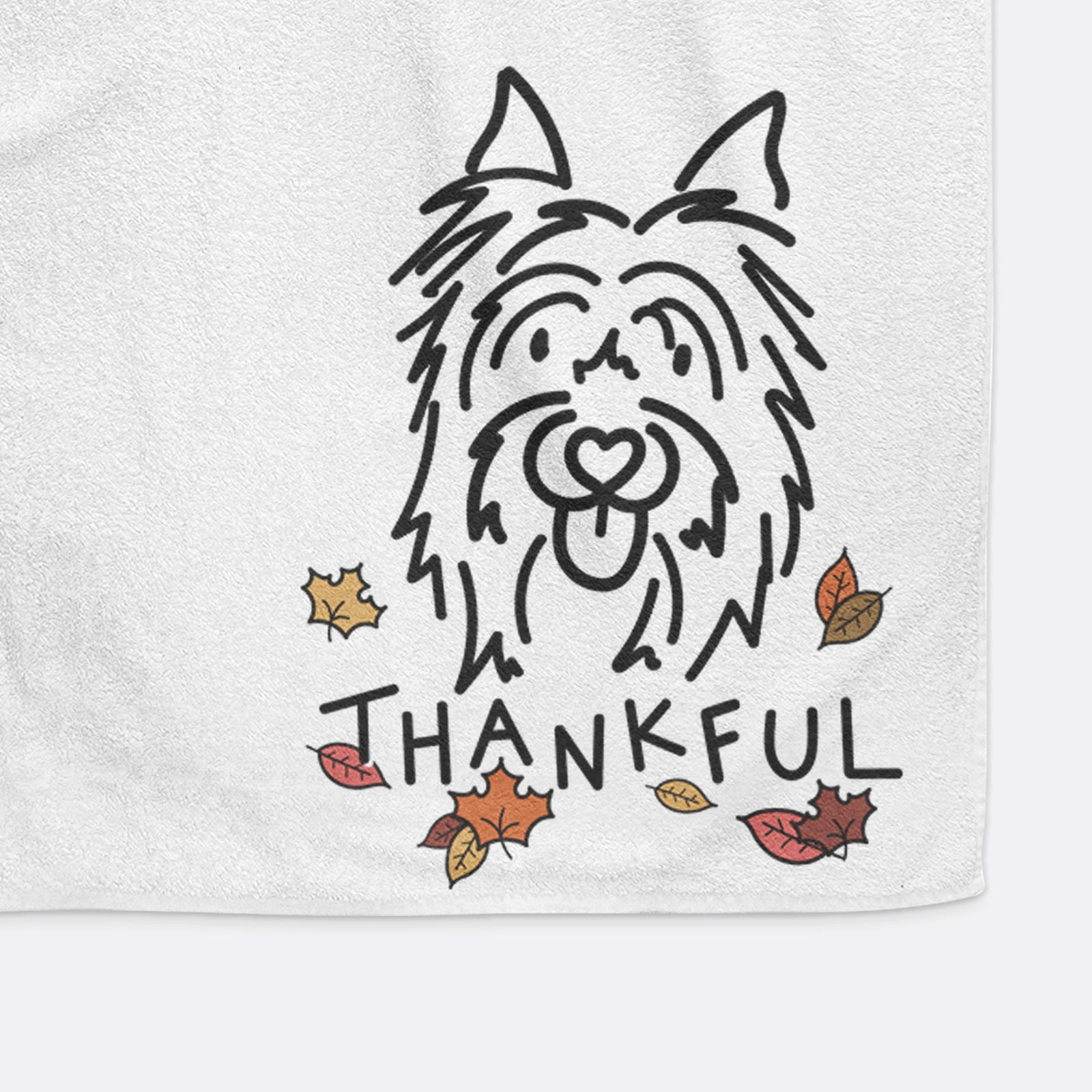 Minimalist line drawing of Monty the Silky Terrier with 'Thankful' lettering on a hand towel