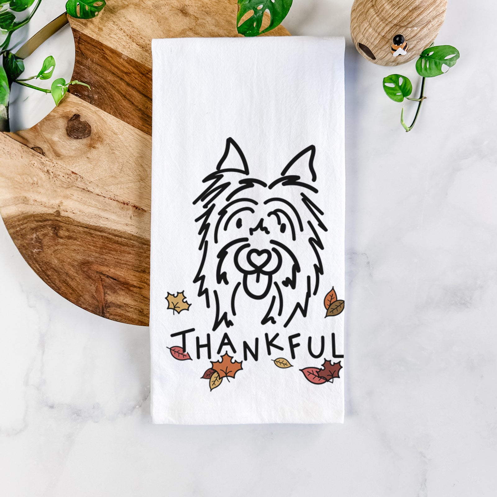 Minimalist line drawing of Monty the Silky Terrier with 'Thankful' lettering on a tea towel