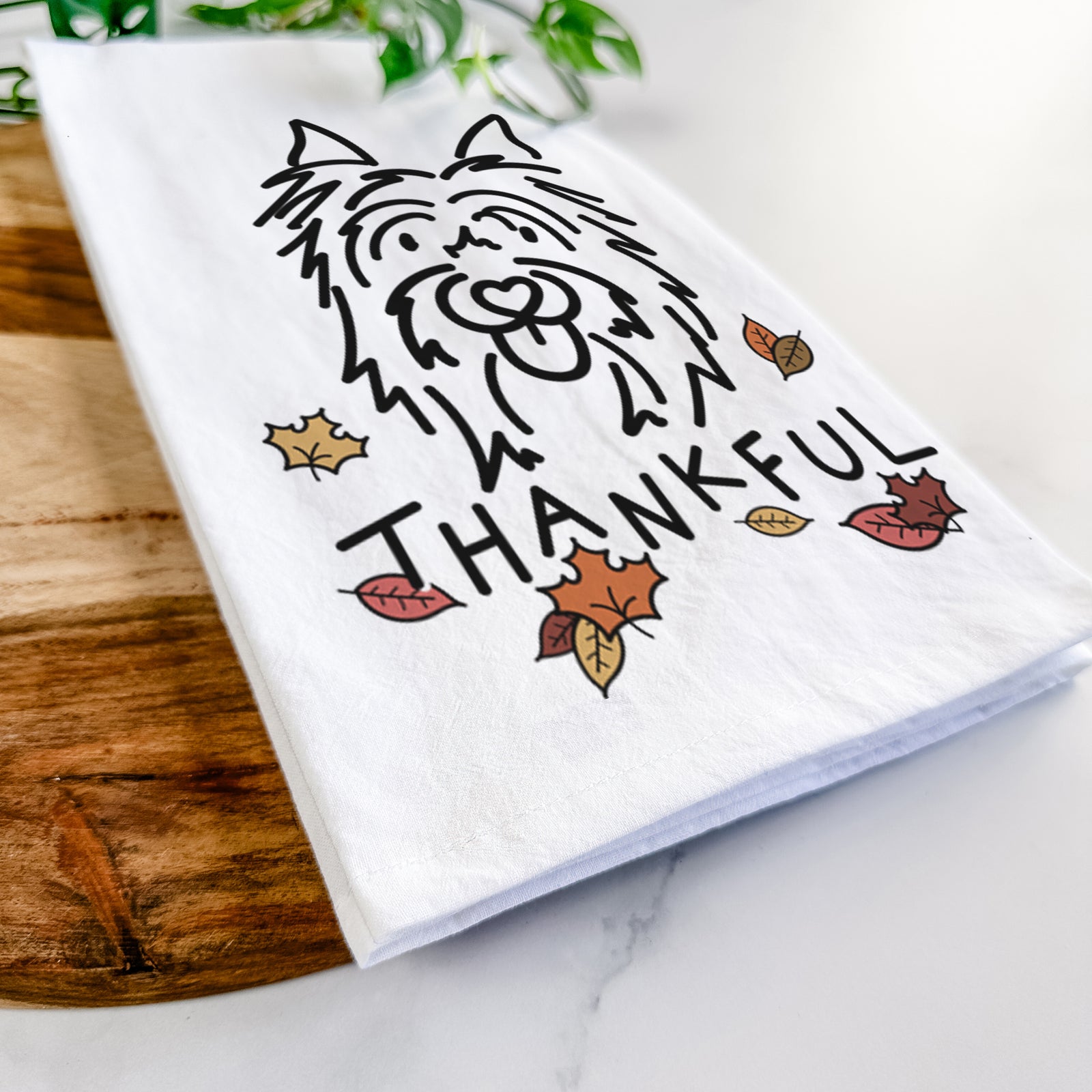 Minimalist line drawing of Monty the Silky Terrier with 'Thankful' lettering on a tea towel
