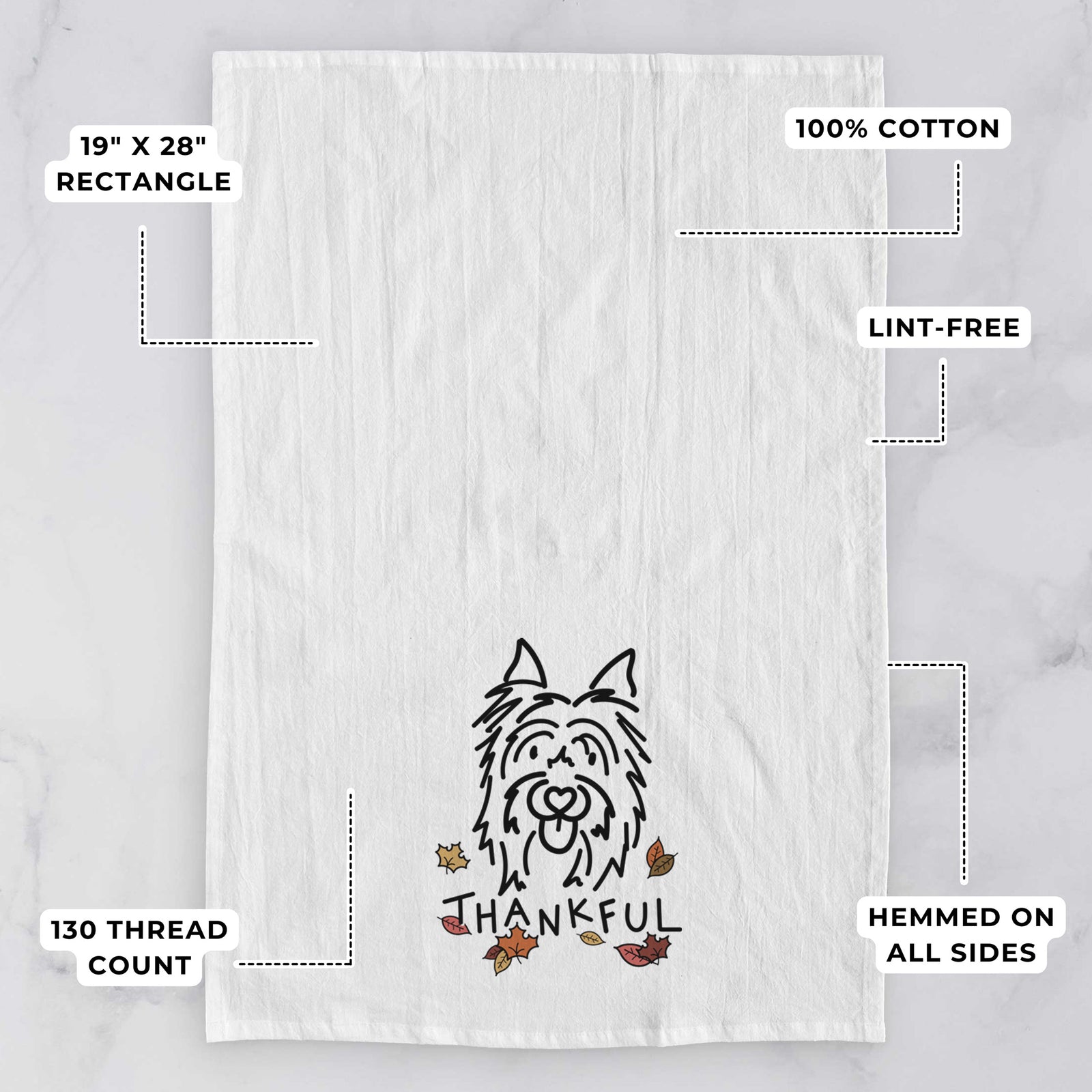 Minimalist line drawing of Monty the Silky Terrier with 'Thankful' lettering on a tea towel, with feature callouts: 19 x 28 inch rectangle, 100% cotton, lint-free, 120 thread count, hemmed on all sides