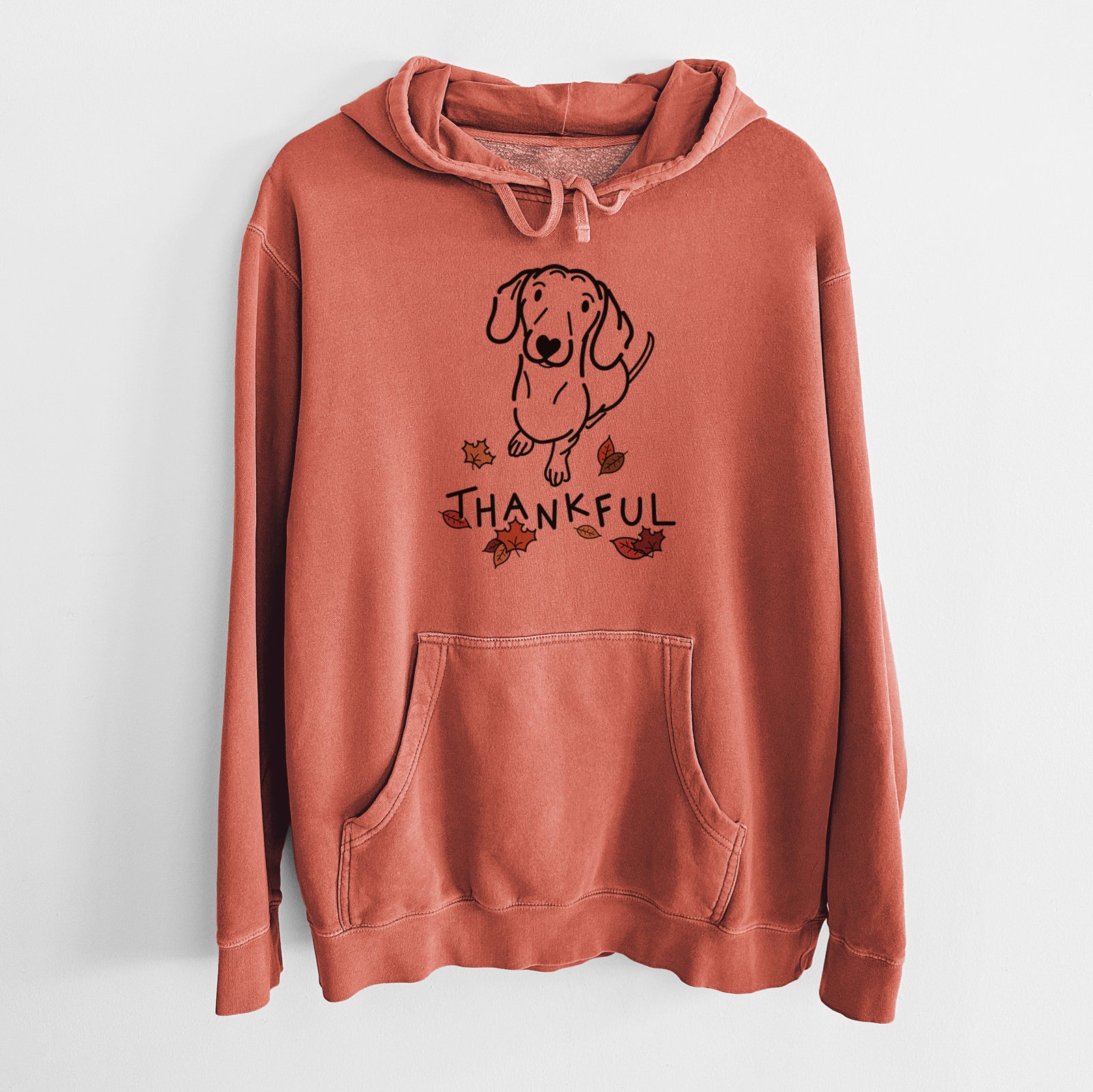 Minimalist line drawing of Moxie the Dachshund with 'Thankful' lettering on an Amber Unisex pigment dyed hoodie