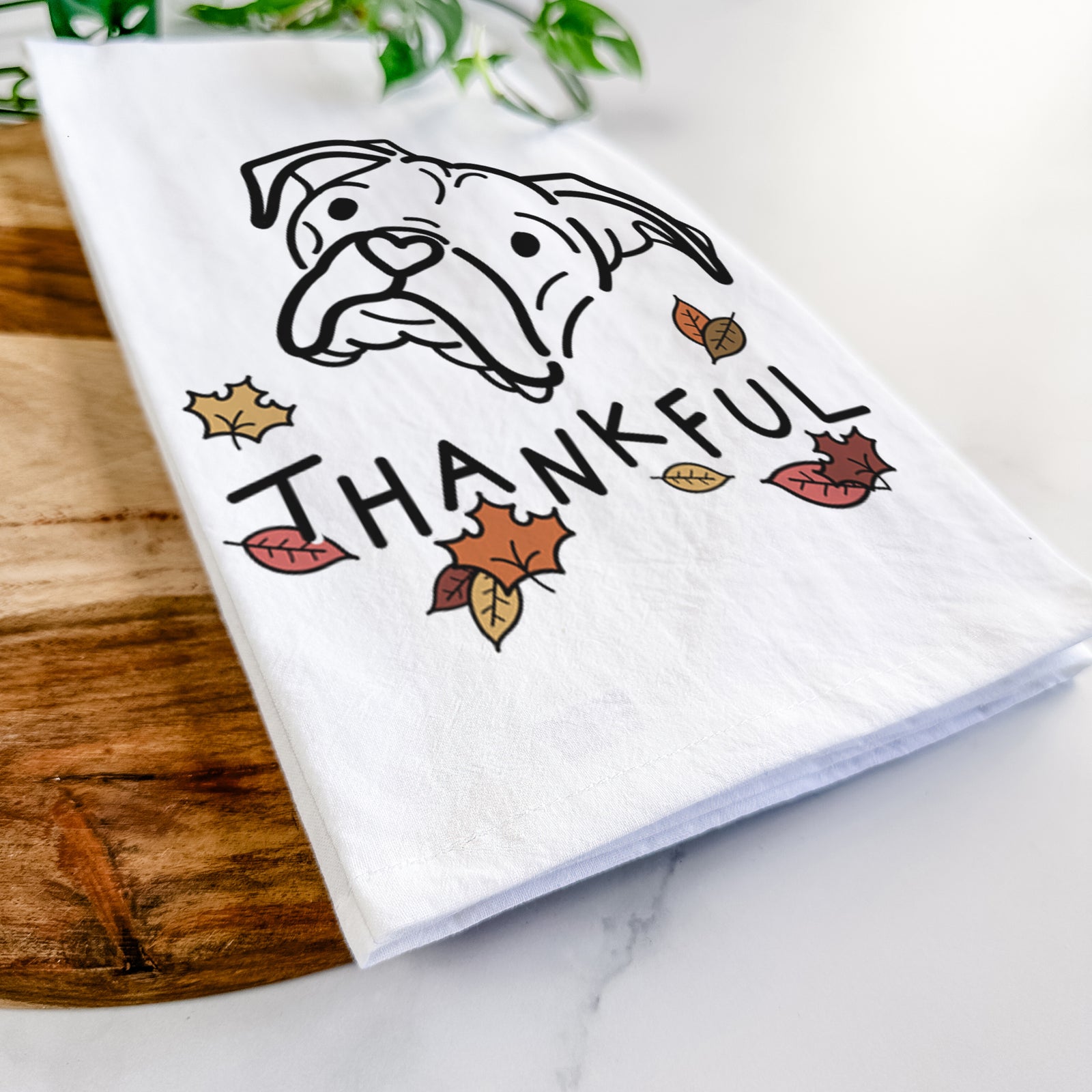 Minimalist line drawing of Noodle the Boxer with 'Thankful' lettering on a tea towel