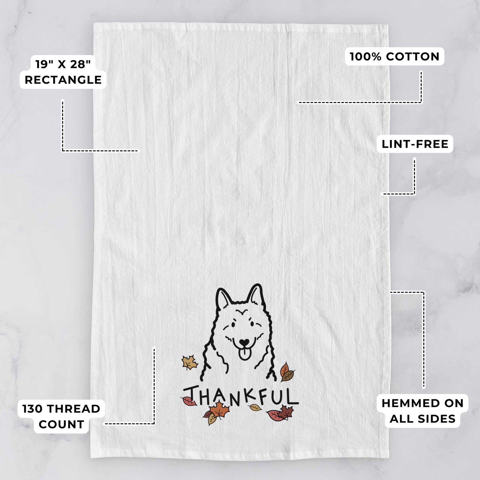 Minimalist line drawing of a Norwegian Elkhound with 'Thankful' lettering on a tea towel, with feature callouts: 19 x 28 inch rectangle, 100% cotton, lint-free, 120 thread count, hemmed on all sides