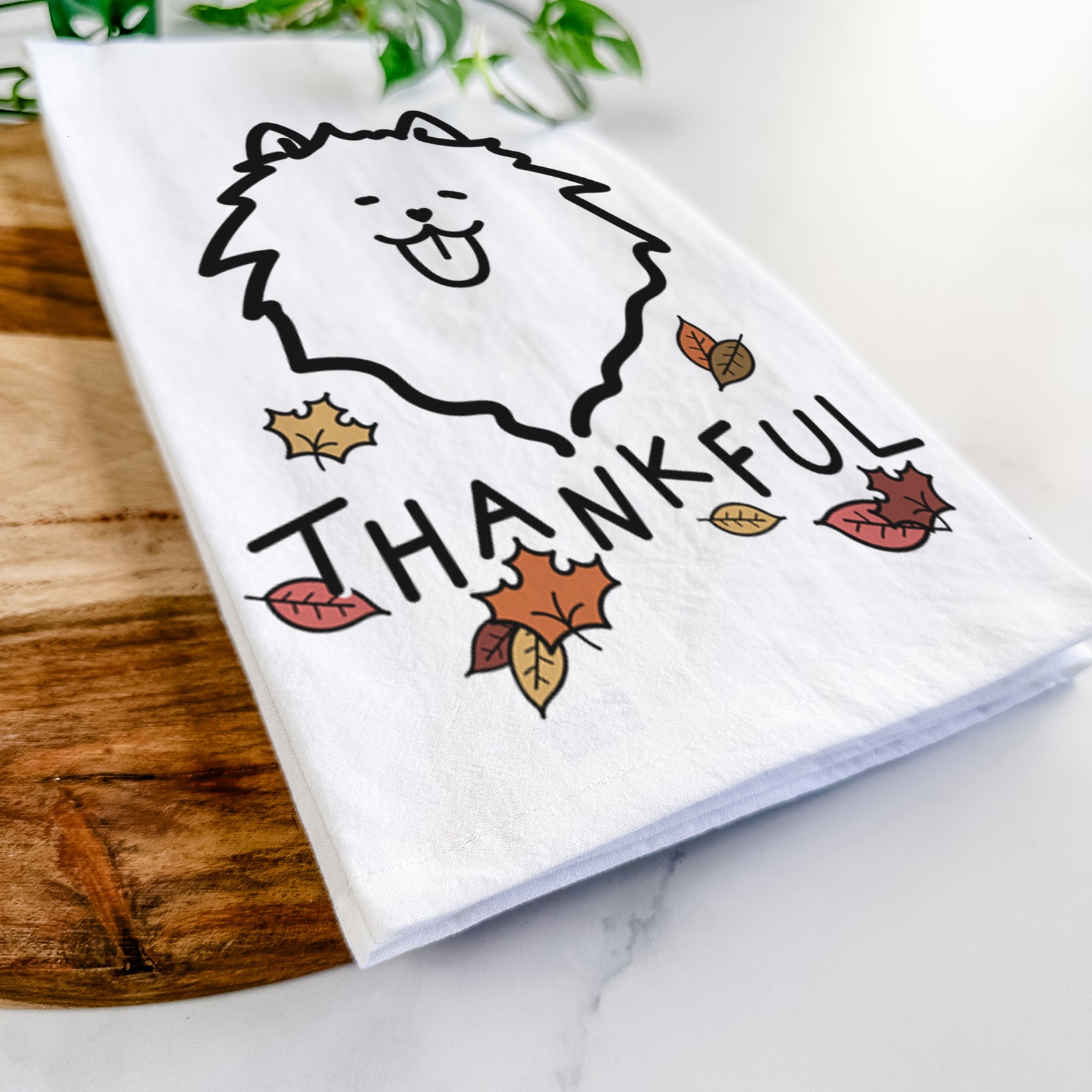 Minimalist line drawing of a Pomeranian with 'Thankful' lettering on a tea towel